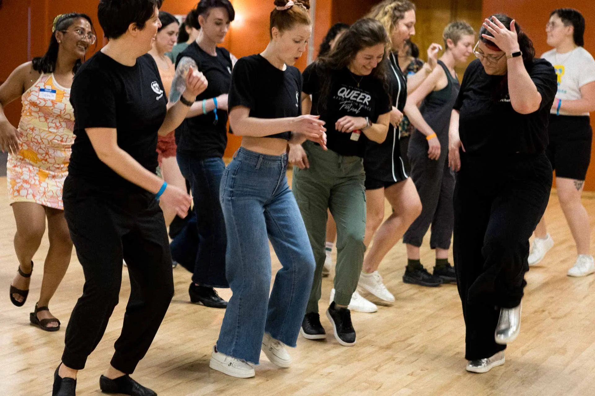 Group of women dancing in a dance class or social event in an indoor setting.