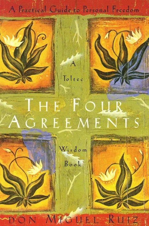 Book cover titled "The Four Agreements: A Practical Guide to Personal Freedom" by Don Miguel Ruiz, featuring a green cross with four stylized flowers in each quadrant, with warm colors like orange, yellow, and purple in the background.