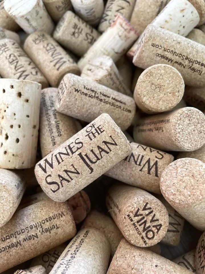 Close-up of wine corks featuring text 'Wines of the San Juan' stacked together.