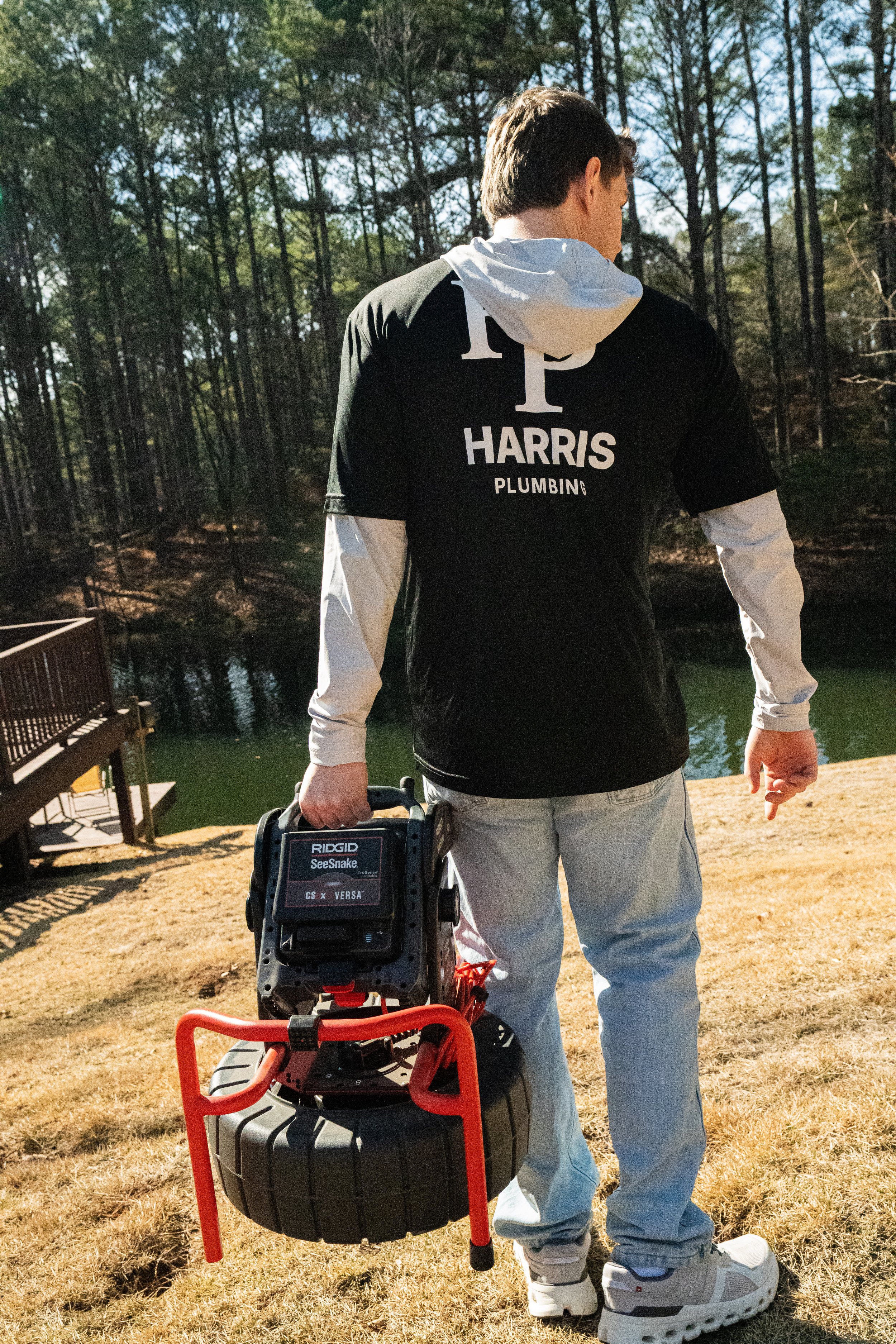 Harris Plumbing team carrying plumbing tools. Plumbing services for remodels and new construction projects in Oxford, MS