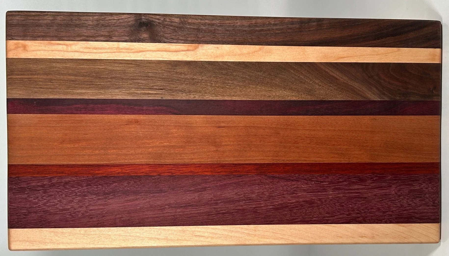 16.25" X 9" Striped Cutting Board made of Walnut, Purple Heart, Padauk and Cherry