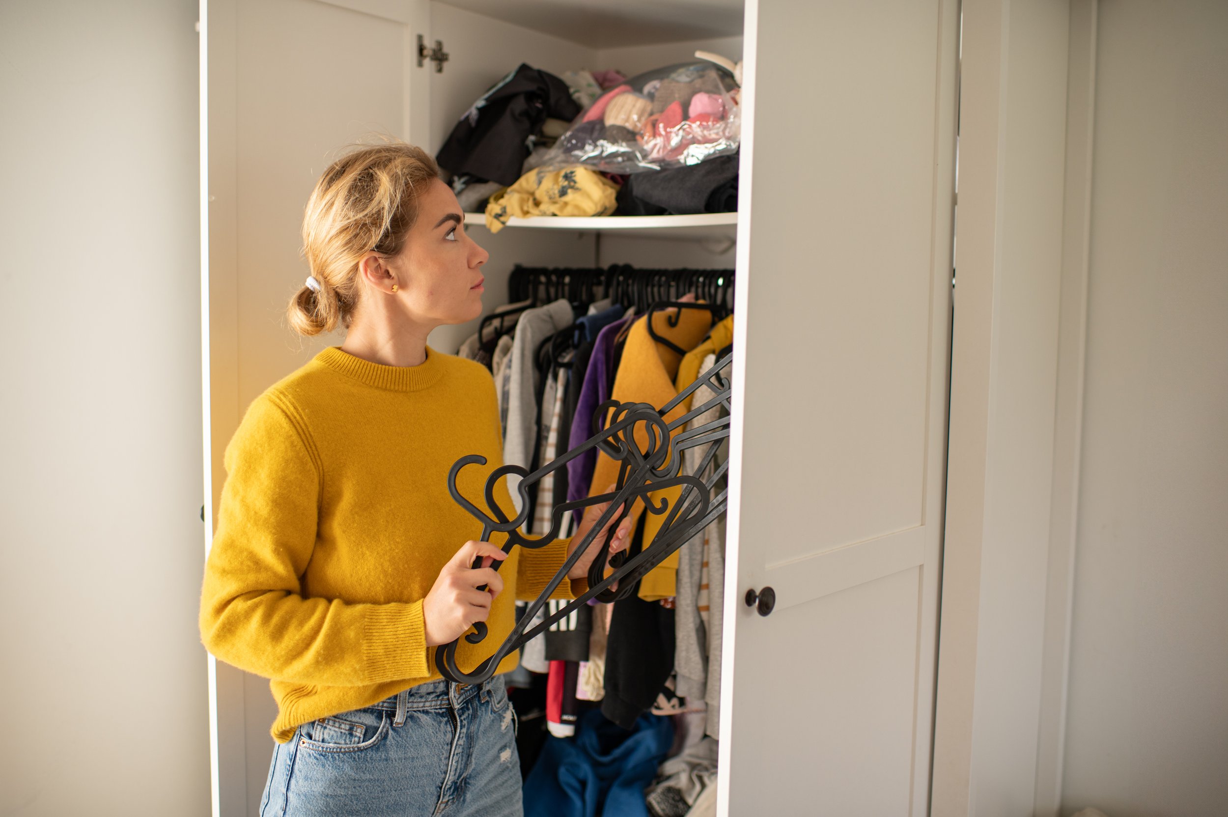 woman organizing chaotic closet in pikesville