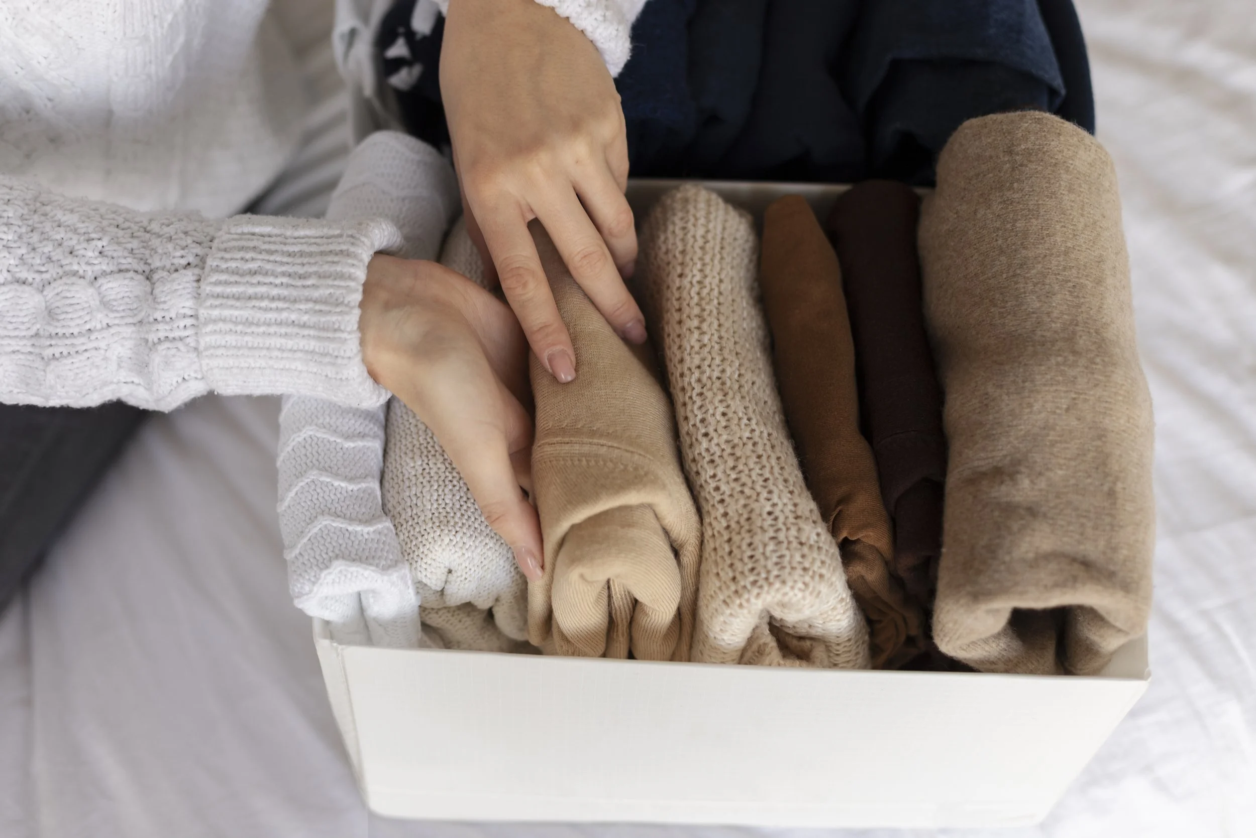 hands folding shirts neat and organized for closet in baltimore