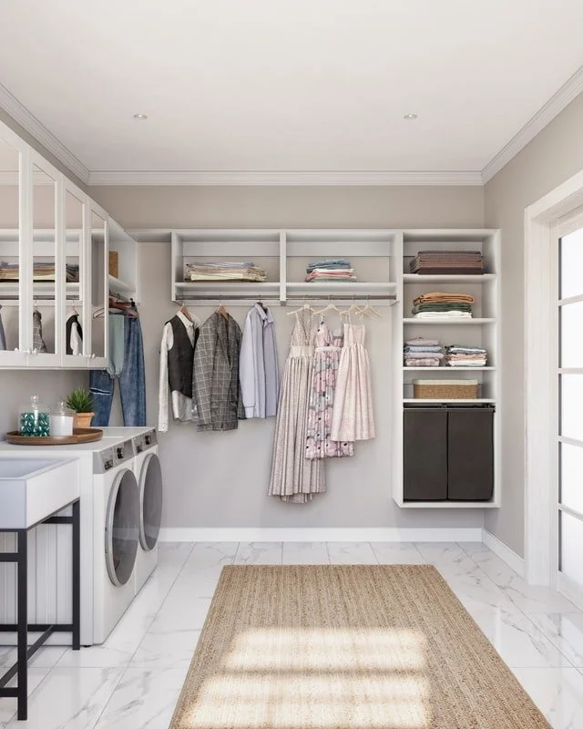 Laundry room with cabinets, hanging clothes, folded towels, and a washer and dryer.