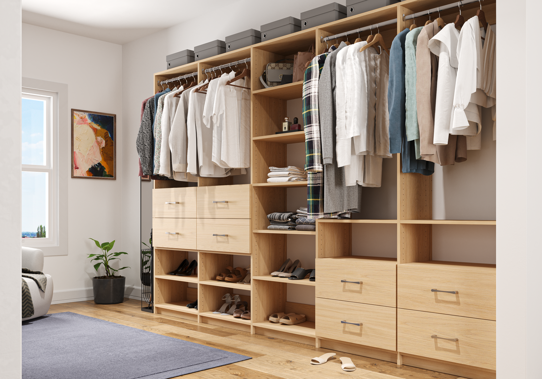 Walk-in closet with shelves of clothing, shoes, and storage boxes, near a window and a sofa.