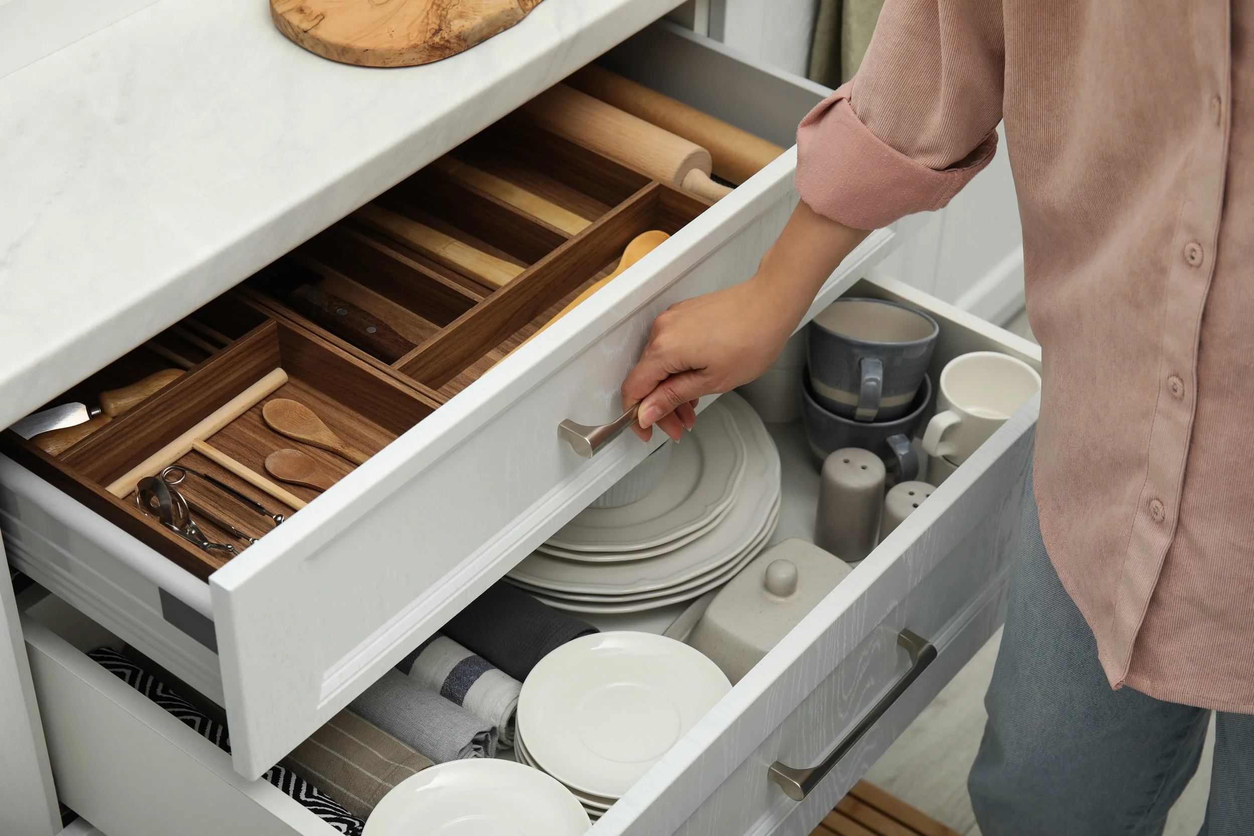Organized kitchen drawer with custom dividers created by a professional home organizer in Marlyand