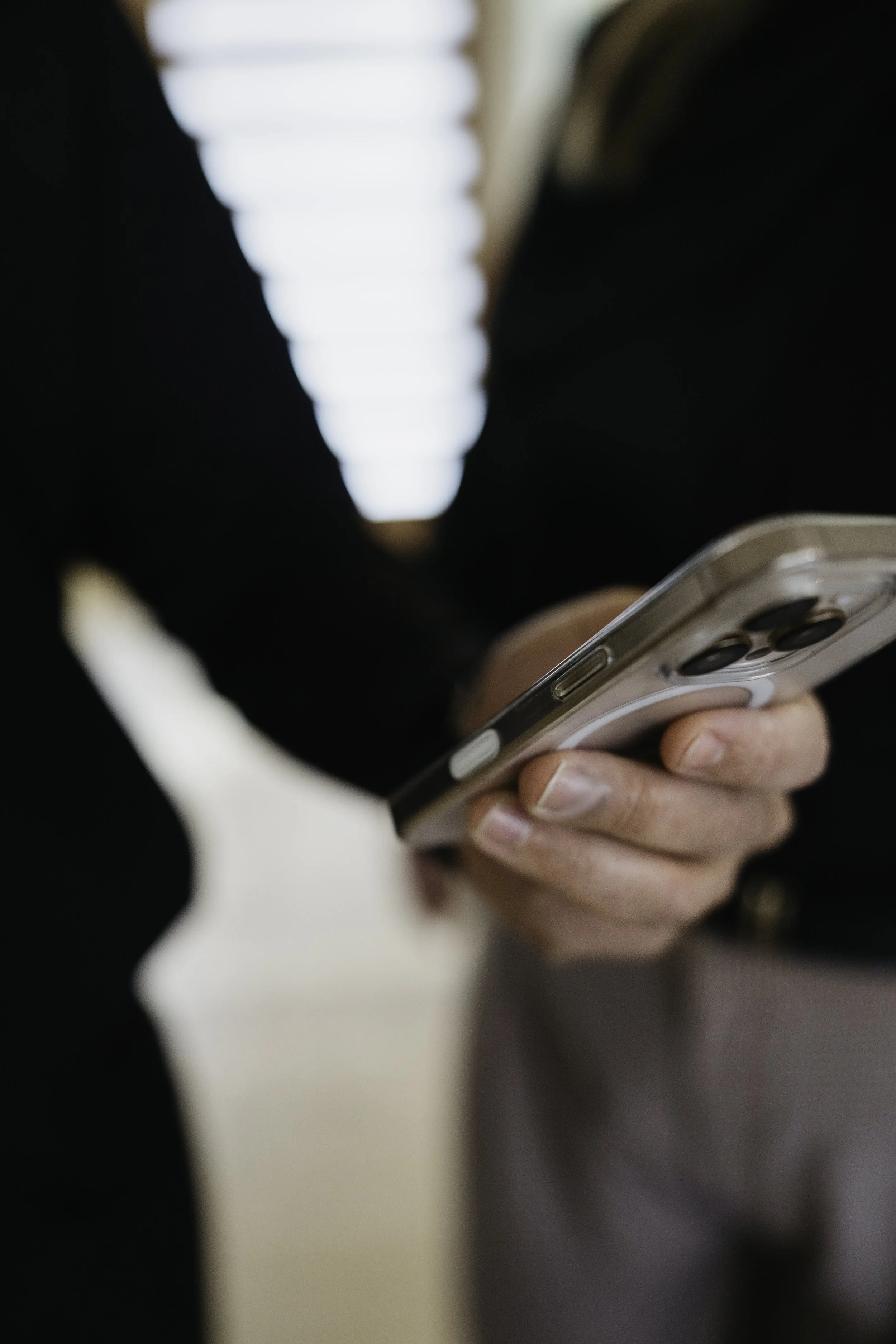 Holding phone checking notifications.