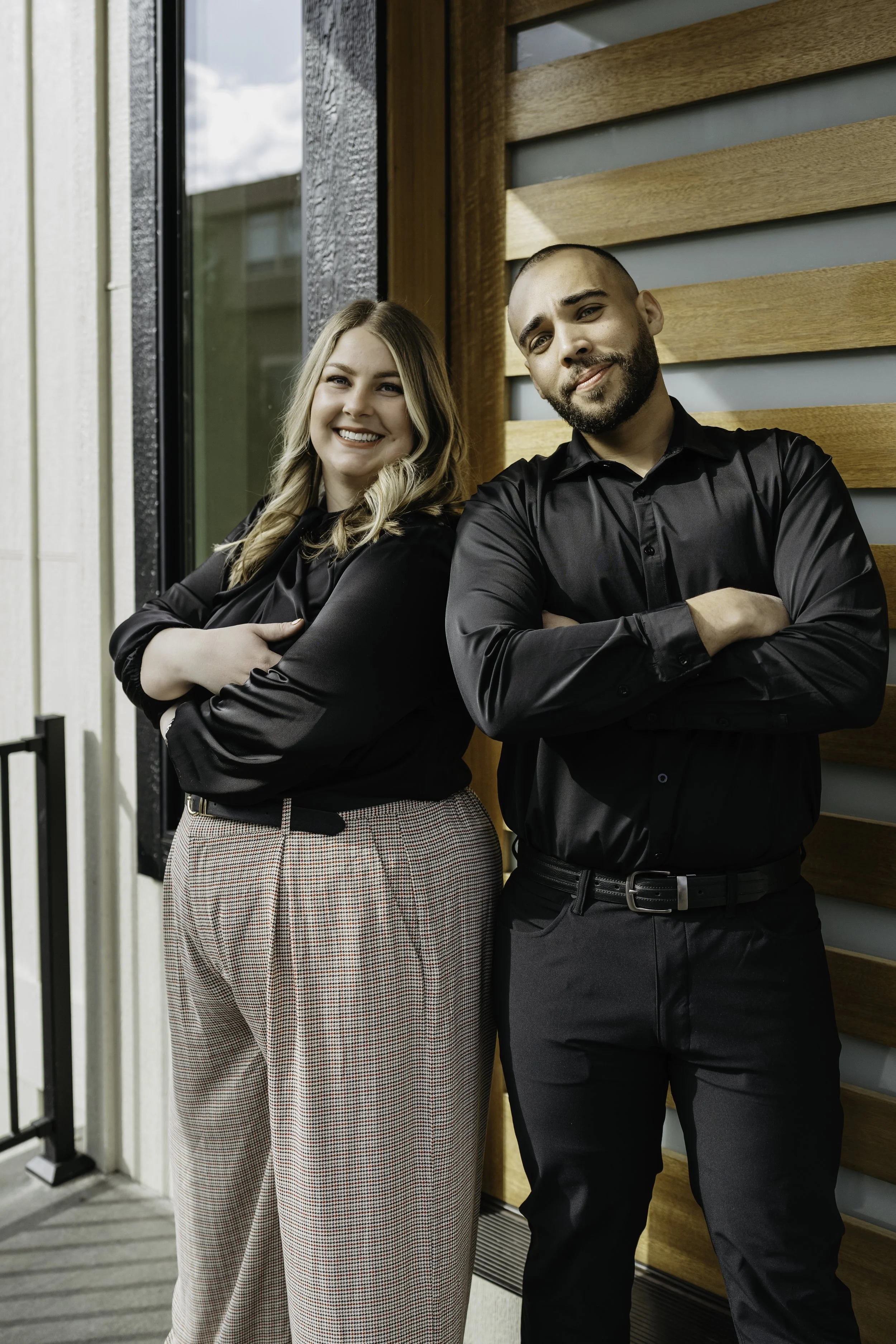Two realtors standing confidently