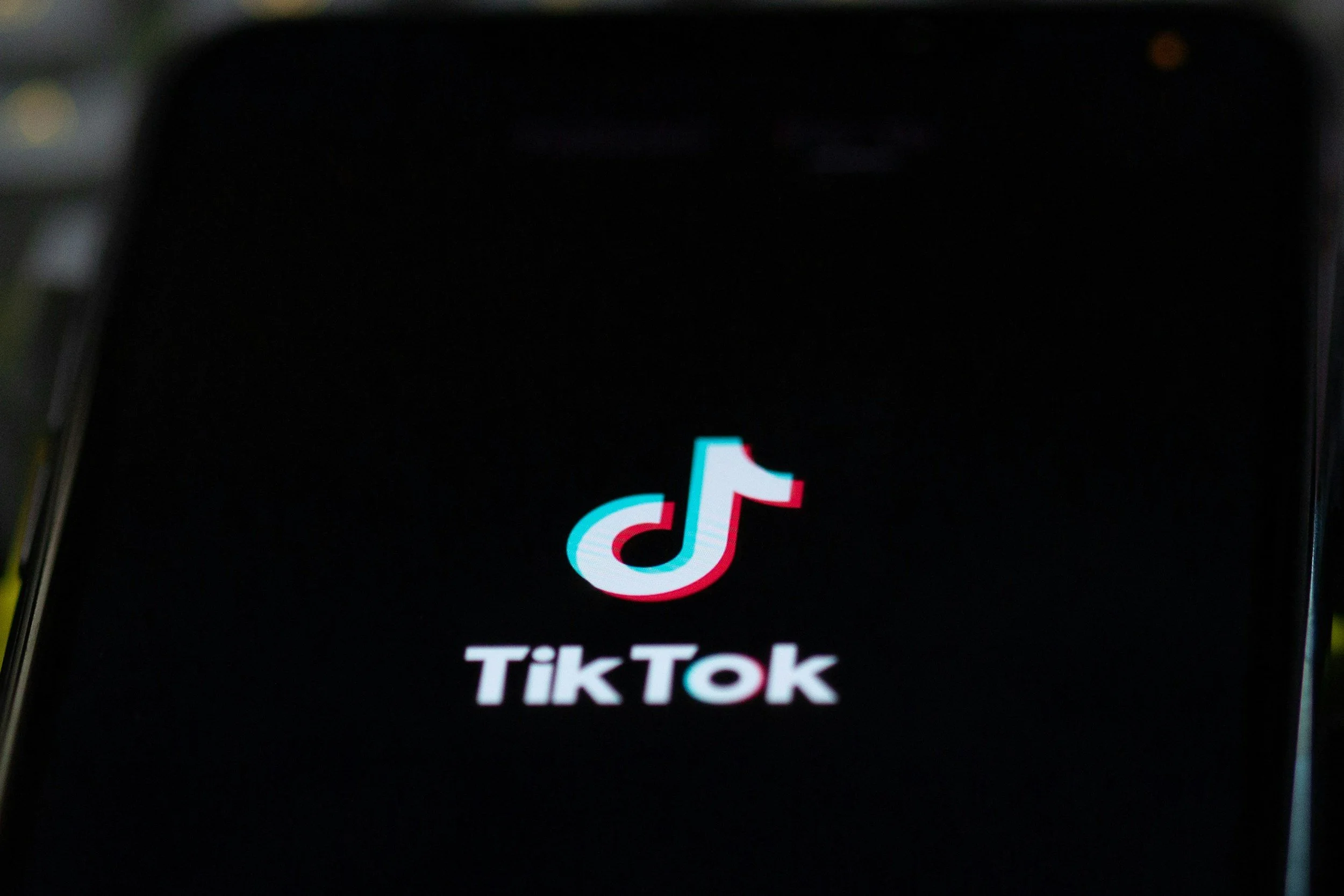 Smartphone displaying the TikTok app logo on a black background.