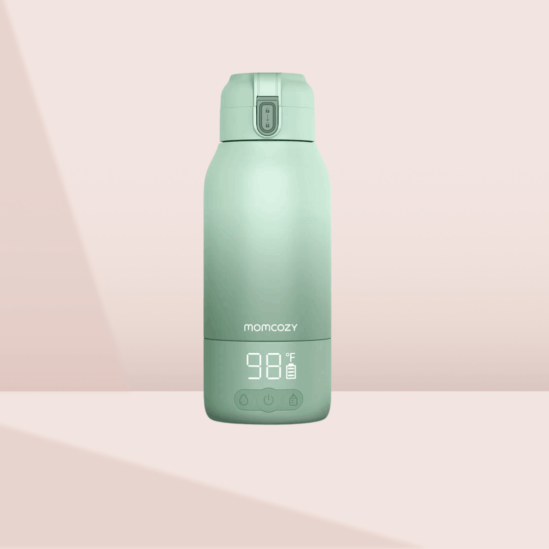 Momcozy Portable Milk Warmer for travel in a sage green finish, showing a digital temperature display of 98°F for warming breast milk or water.