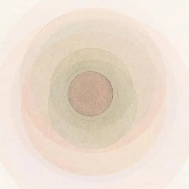 Colorful concentric circles creating a rainbow effect on a light background.