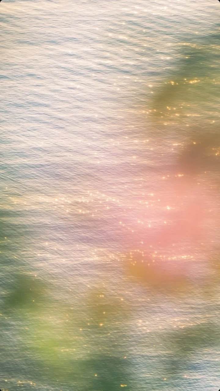 Close-up of sunlight reflecting off water with rainbow-like colors and sparkling effects.