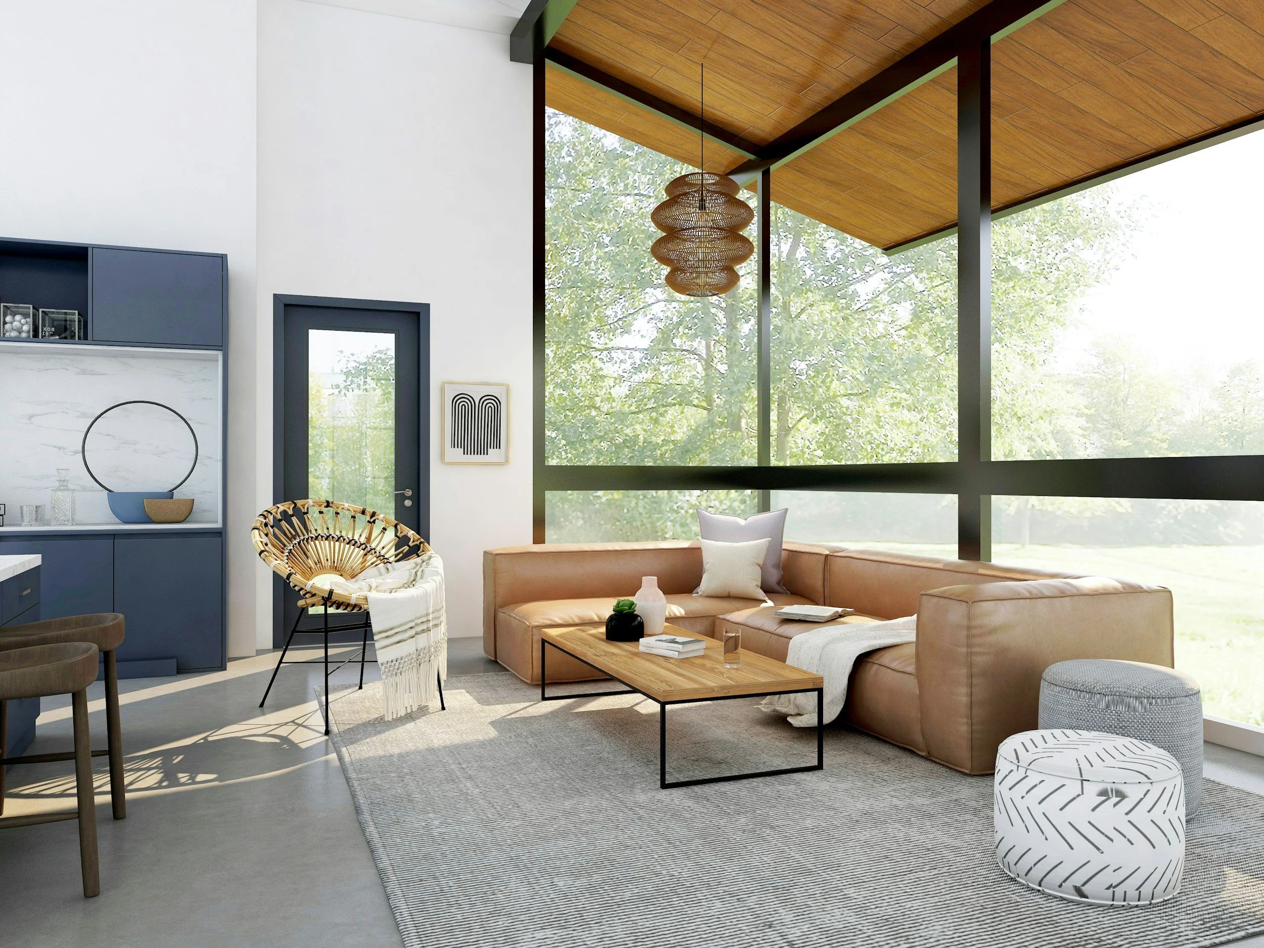 A modern living room with large floor-to-ceiling windows showing green trees outside. The room features a tan leather sectional sofa with pillows, a wooden coffee table, a white and black patterned pouf, and a round woven chair. There is a black-bordered artwork on the wall, a white side table with decorative items, and a large white and gray area rug. The ceiling is wooden with a hanging rattan pendant light.