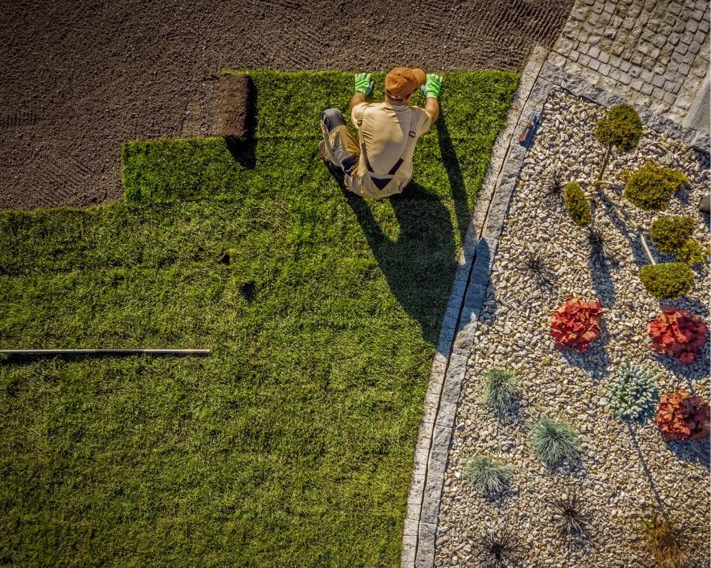 Landscape construction worker installing lawn as a part of landscaping service provided by the best landscape company in Bend