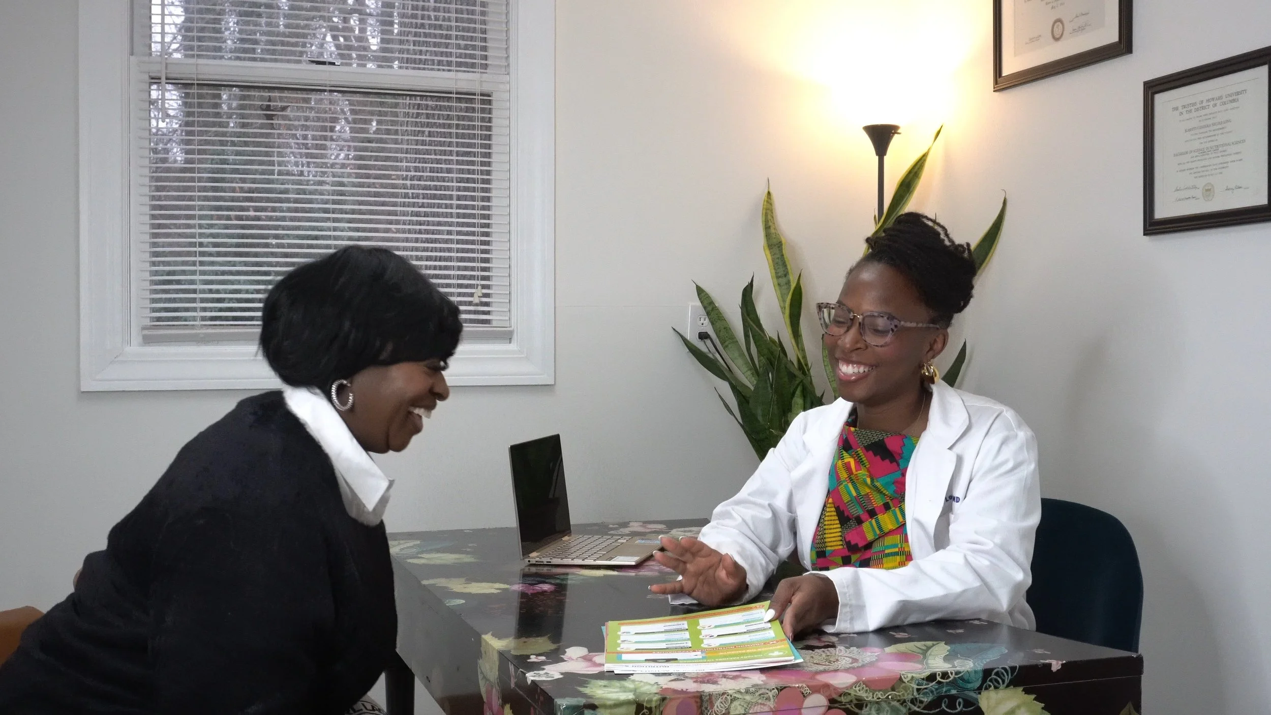 Patient meeting with a physician for a comprehensive, whole-person health consult.