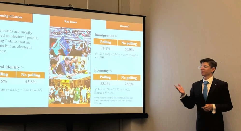 A man in a suit giving a presentation in front of a projected slide with data and images related to Latino voting patterns.