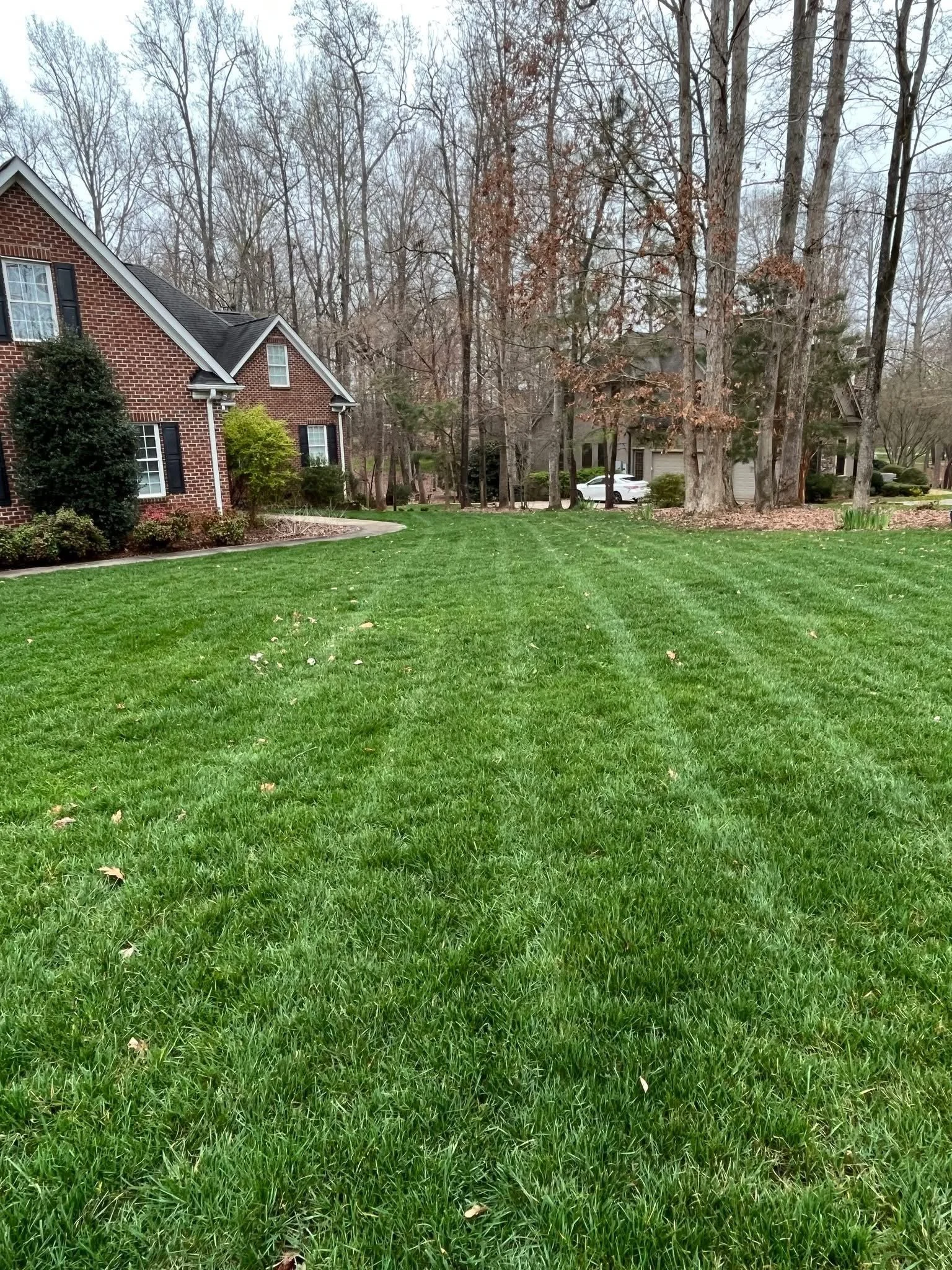 Brick house with dense green lawn
