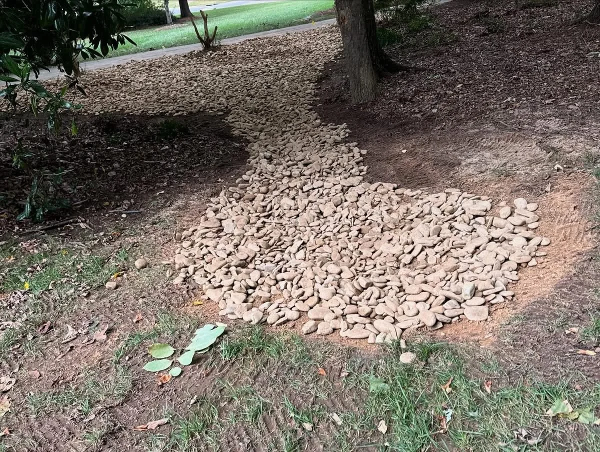 Yard drainage solution with river rock