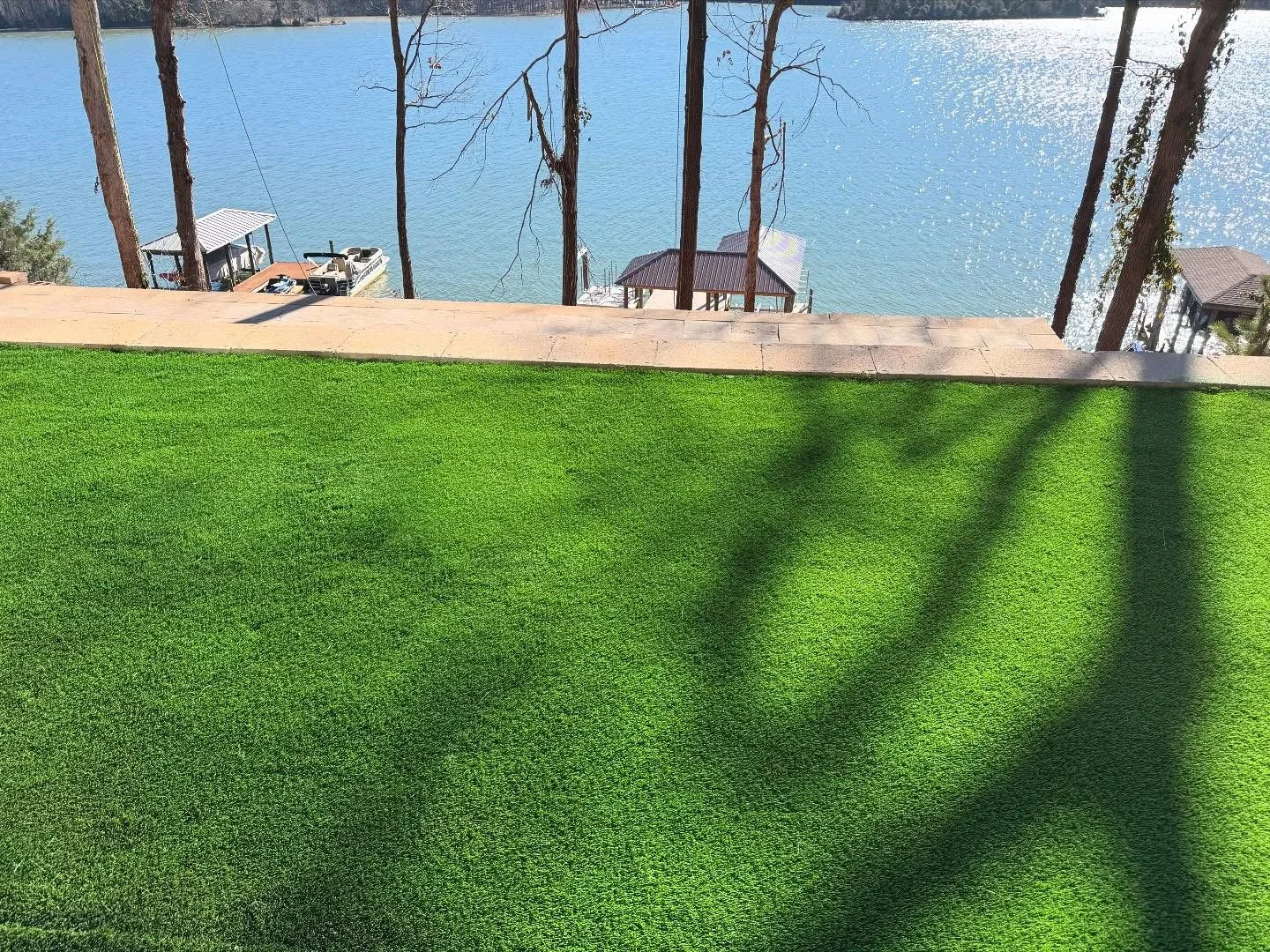 Artificial turf with lake and docks in background 
