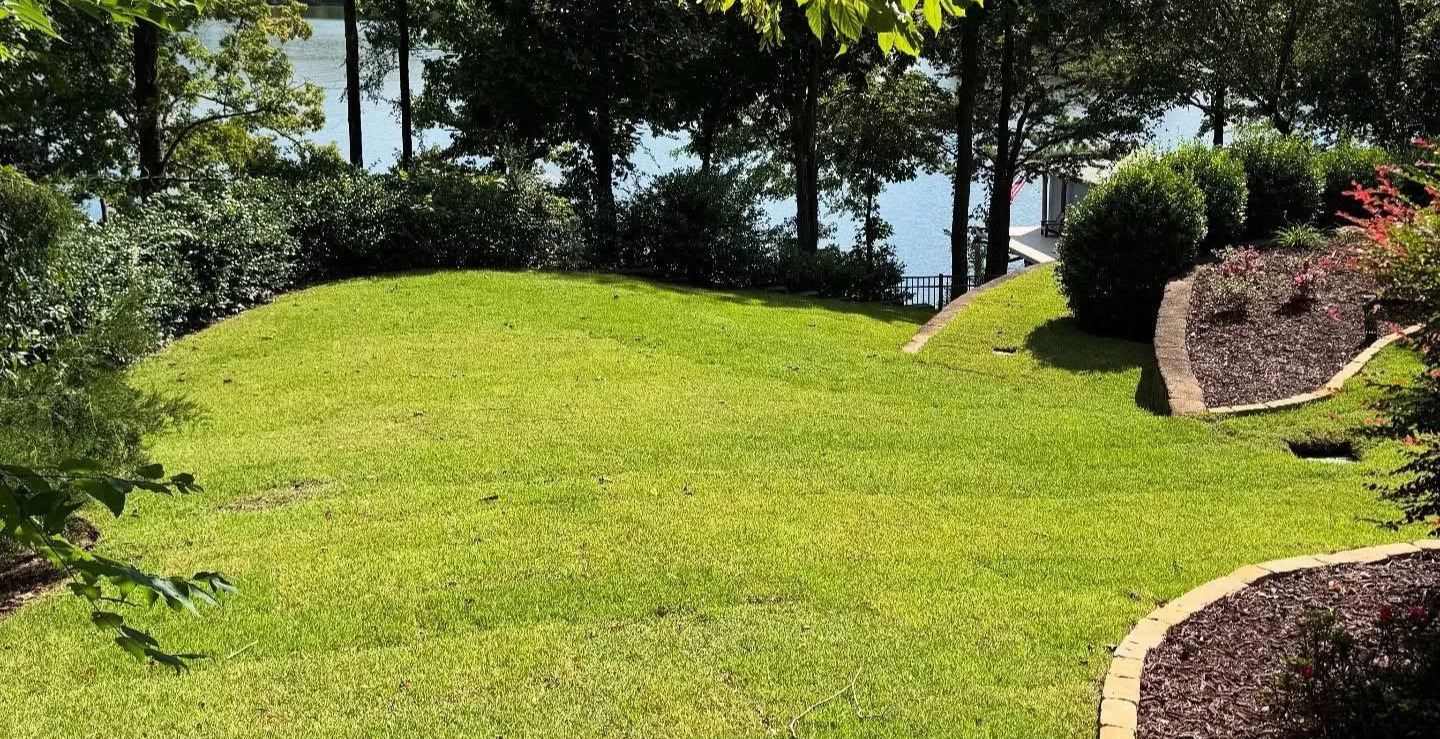 Sod installation and mulched garden beds at lake house