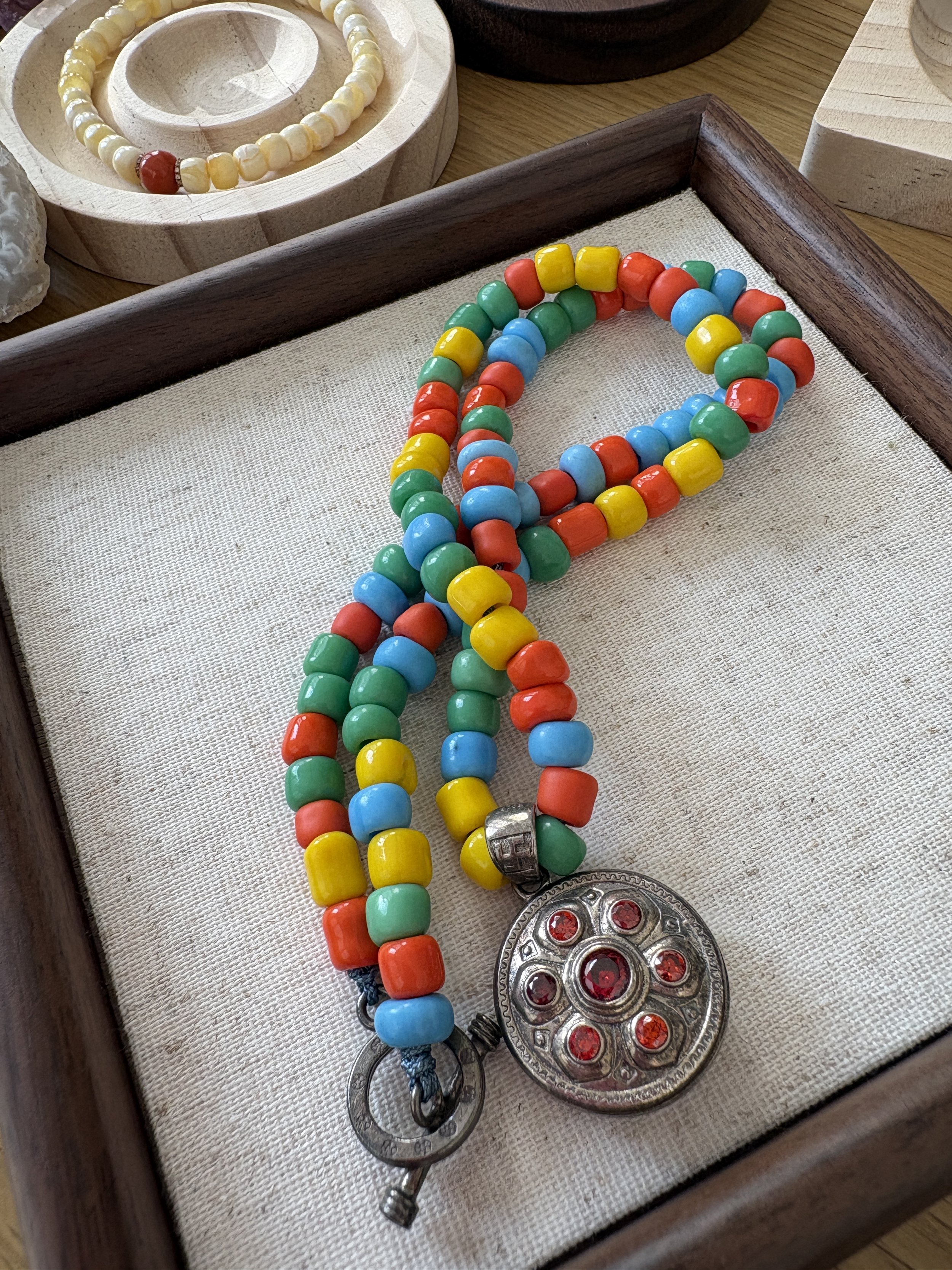 Vibrant Beaded Necklace with Silver Pendant and Orange Gemstones
