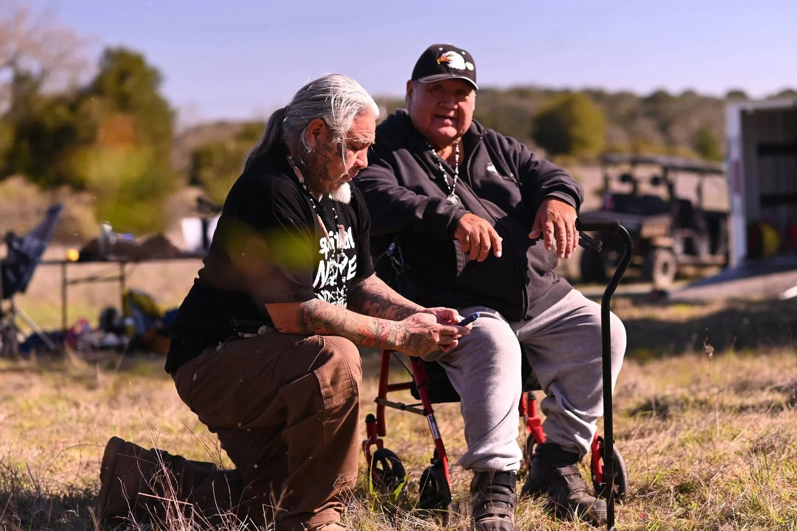 Two Muwekma Ohlone elders talk beside the cultural burn at 'Ootchamin 'Ooyakma (Jasper Ridge)