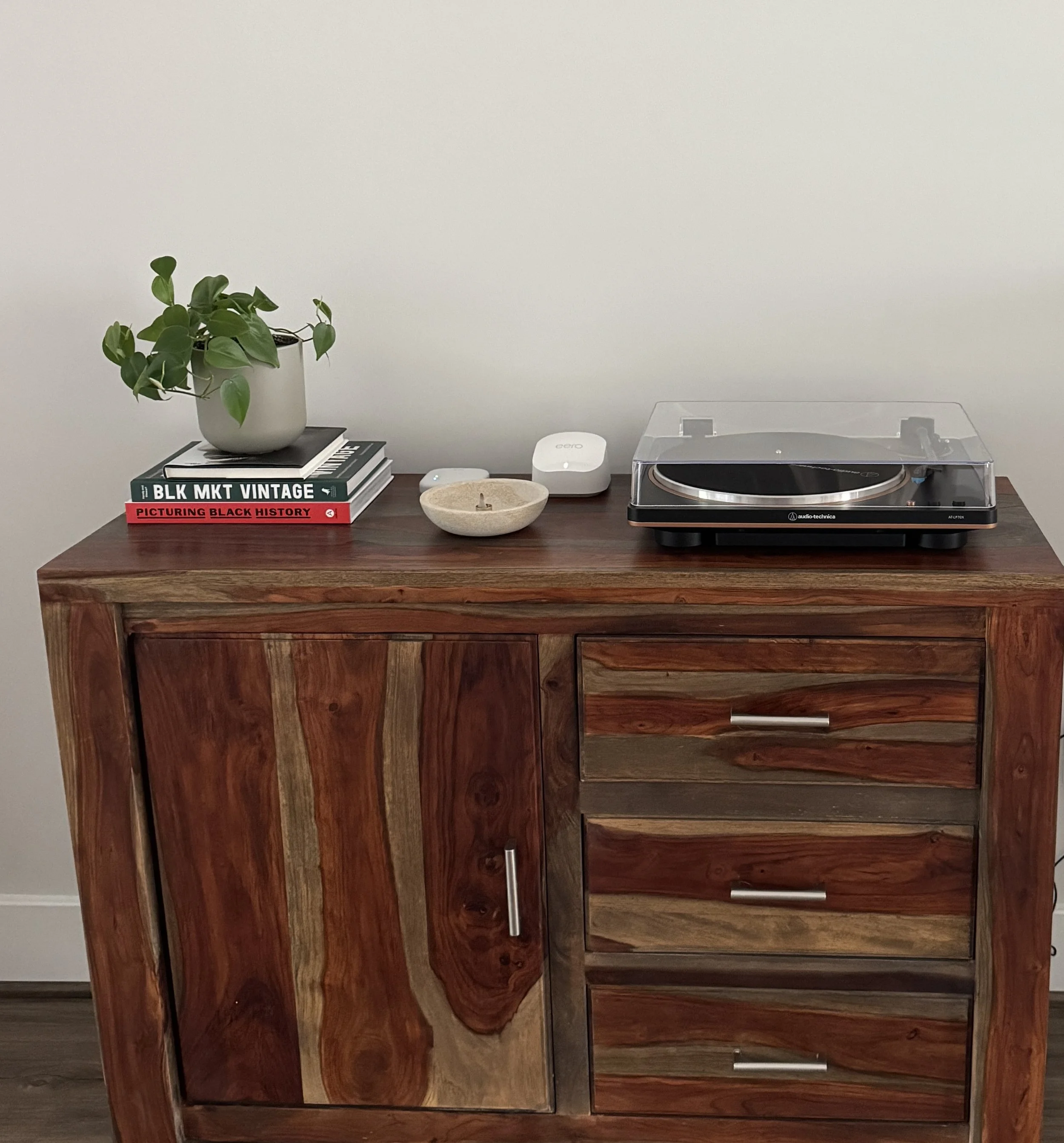 Audio Technica turntable with Eero mesh node professionally configured on top of a cabinet.