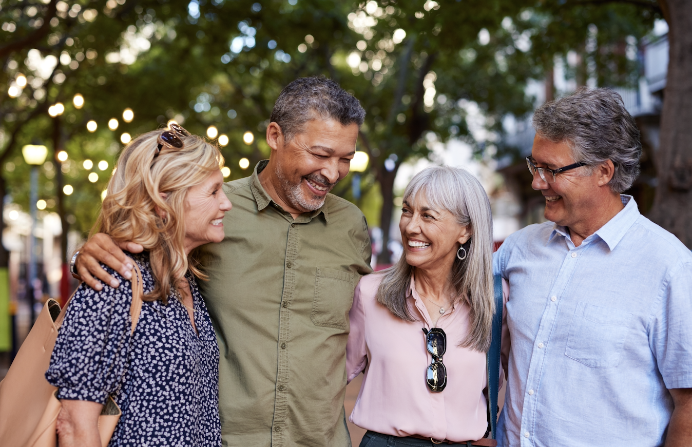 Friends sharing a sunrise moment, hugging and smiling.