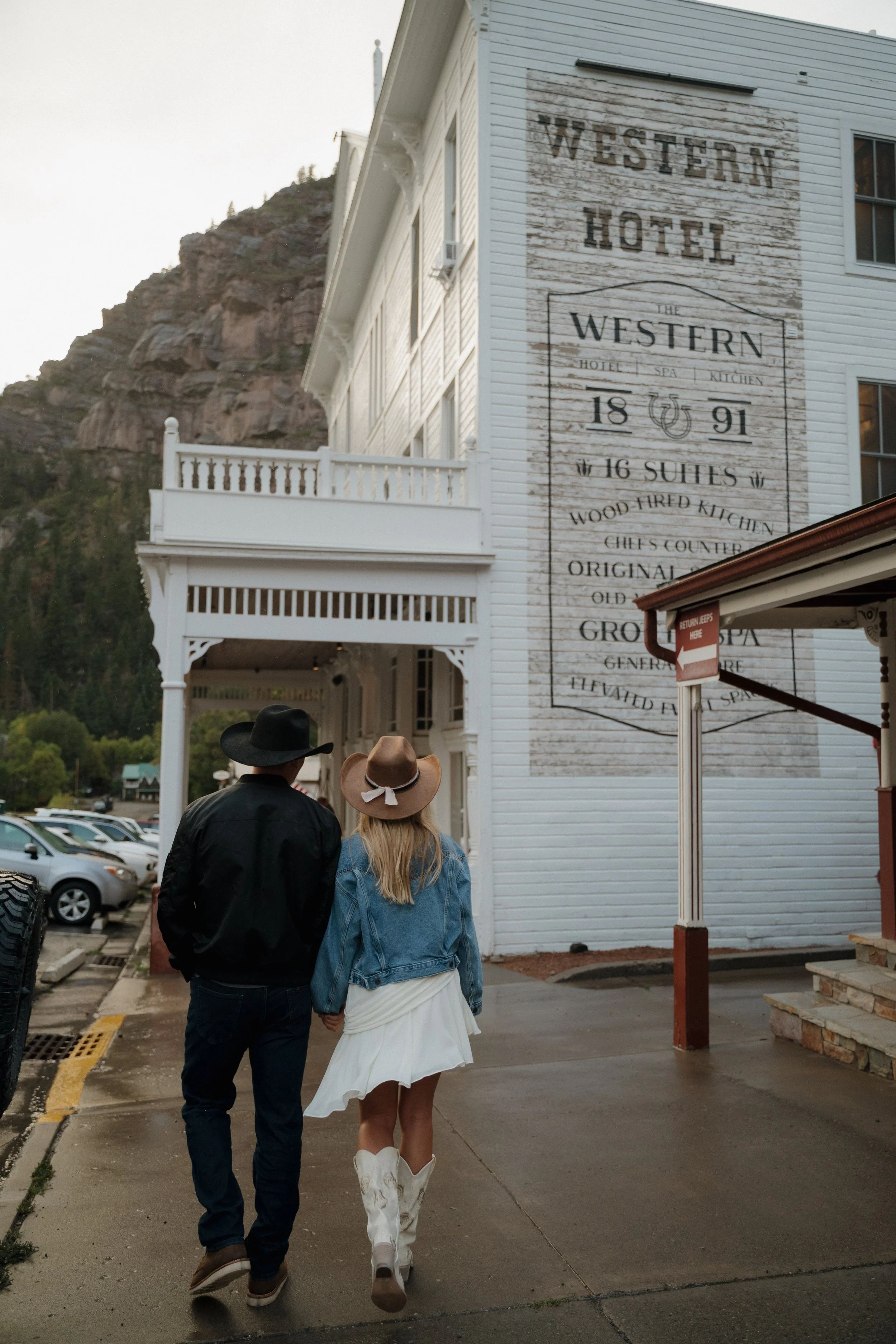 A Bride and Groom Walk To Their Wedding Reception Designed By Mountain Arrow Events and Rentals at The Western Hotel Ouray, CO