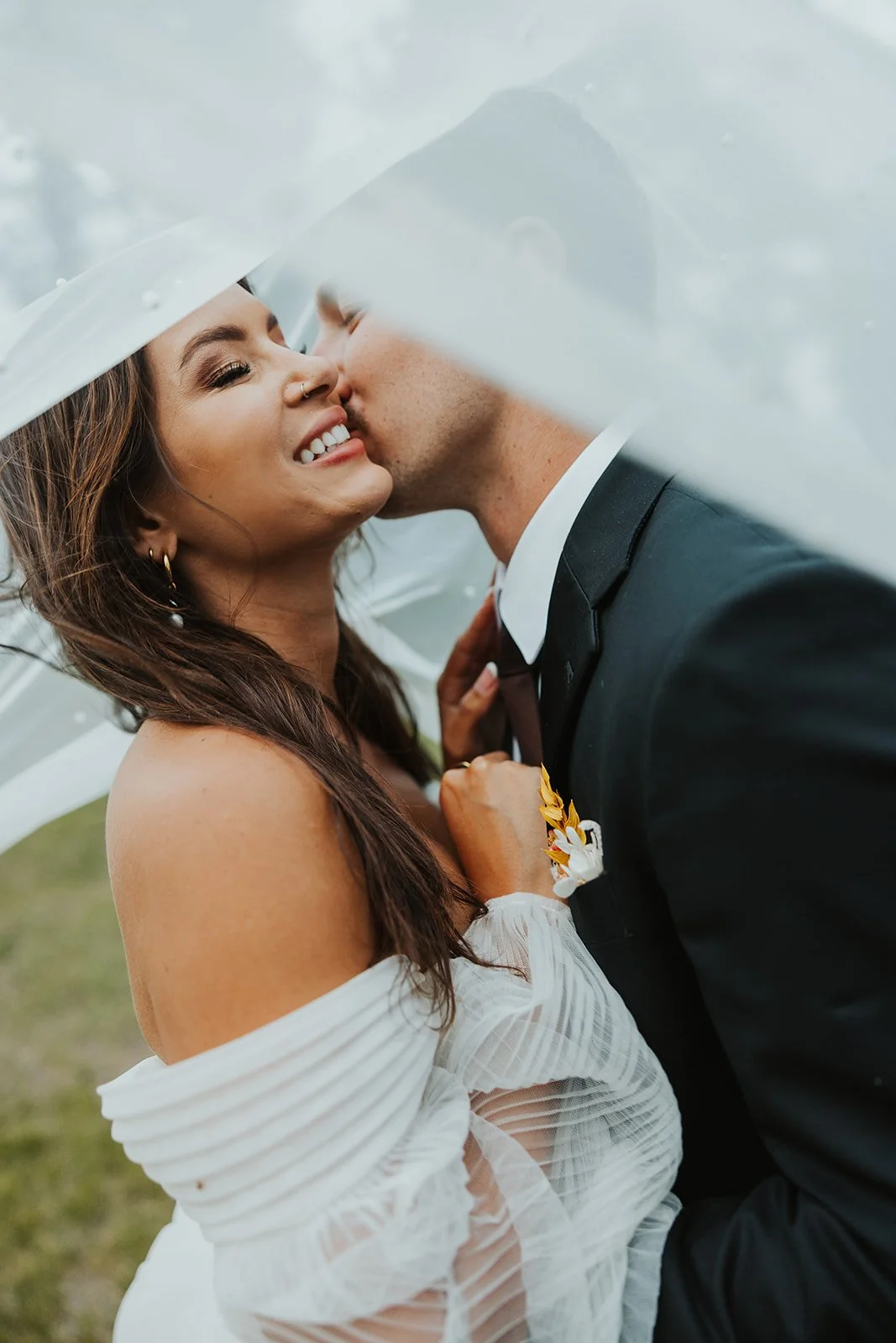 A Modern Bride and Groom Kiss Underneath The Bride's Veil At Their Mult-Day Destination Wedding Planned and Styled By Mountain Arrow Events and Rentals