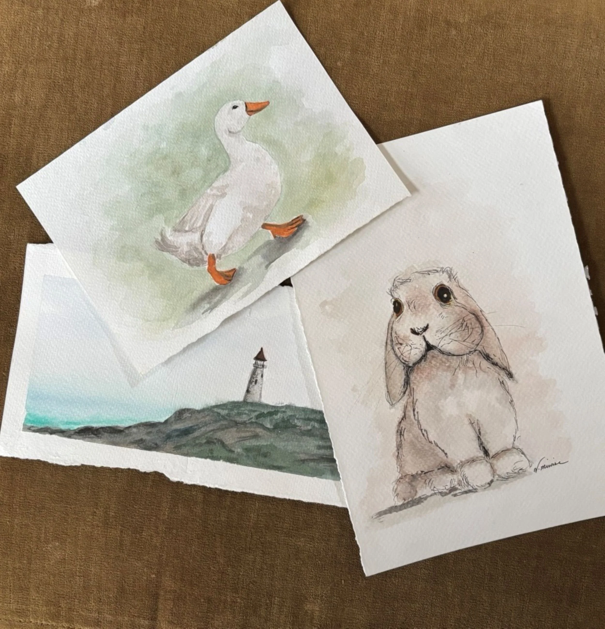 Watercolor painting of a white goose with an orange beak and feet, standing on a branch with a soft green background and a watercolor rabbit.
