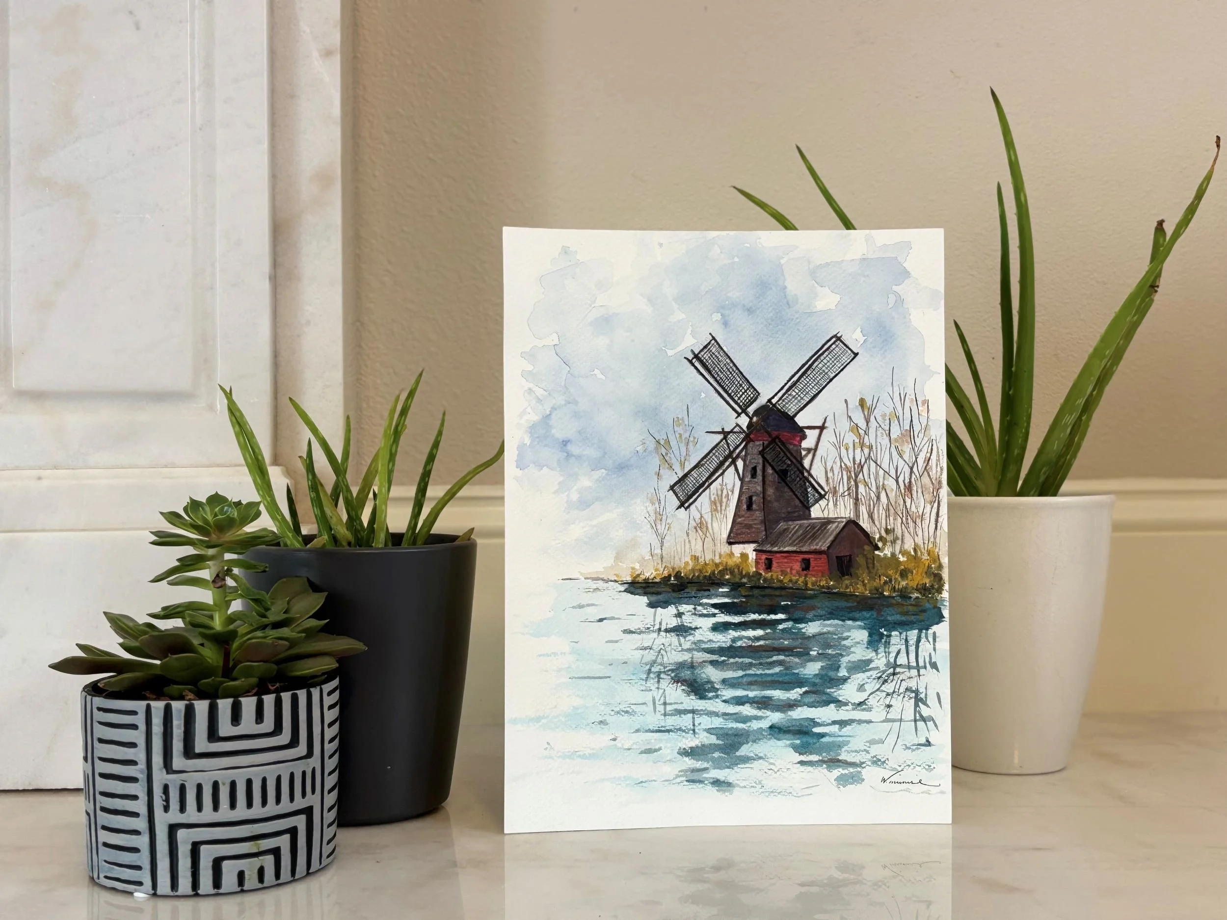Detail of Origin watercolor landscape showing a quiet windmill and reflective rural water