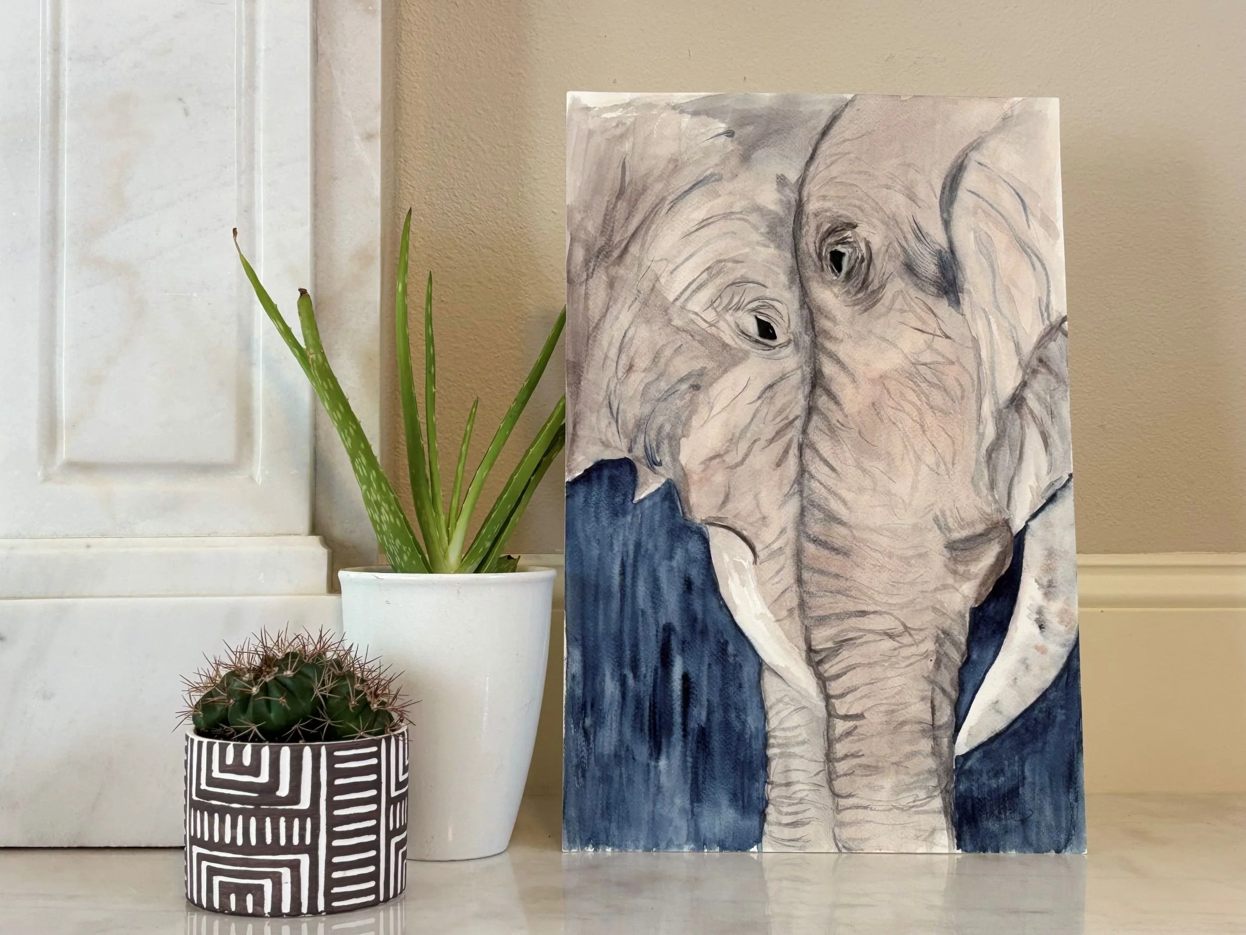 Detail of Pheelings watercolor painting showing two elephants meeting gently with their foreheads touching