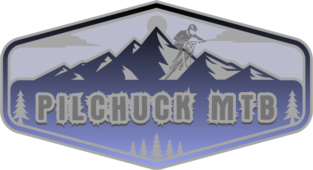 A mountain scene with a mountain biker jumping off a cliff, surrounded by mountains and pine trees. The text 'PILCHUCK MTB' is in the center in bold, rocky style.