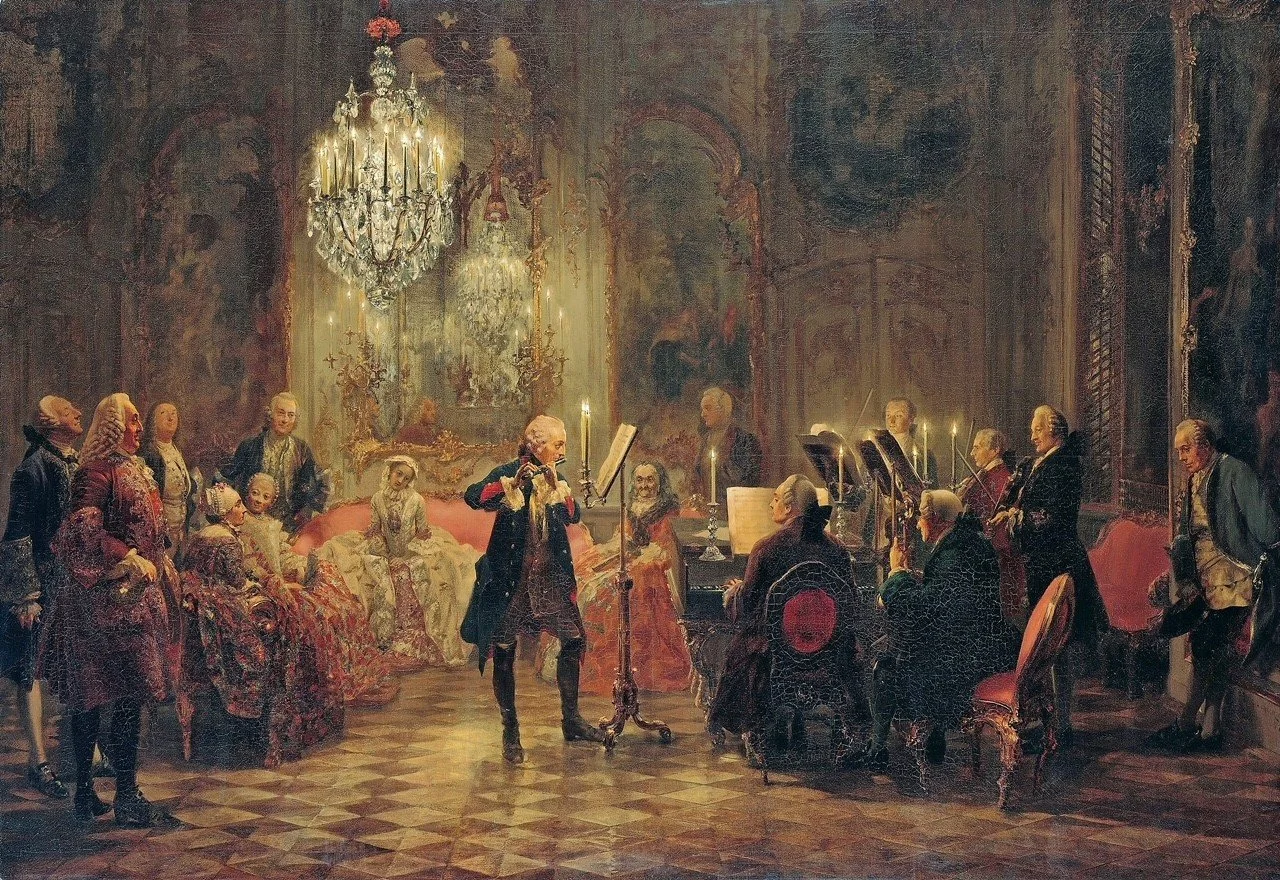 A classical painting depicting a live musical performance in an elegant room with ornate decorations, a chandelier, and people dressed in historical attire, including a violinist at the center, a pianist, and an audience of seated and standing guests.