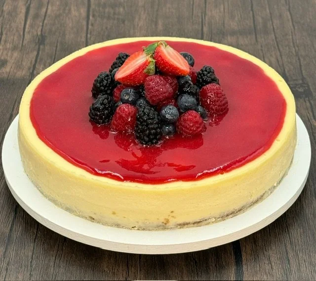 Full cheesecake with raspberry sauce.JPG