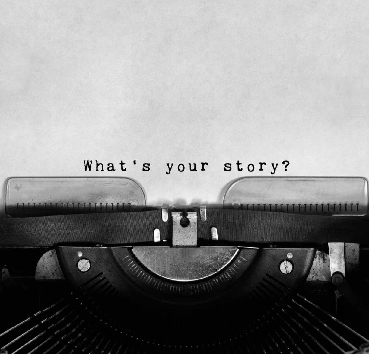 Close-up of a vintage typewriter with the question "What's your story?" typed on a sheet of paper.