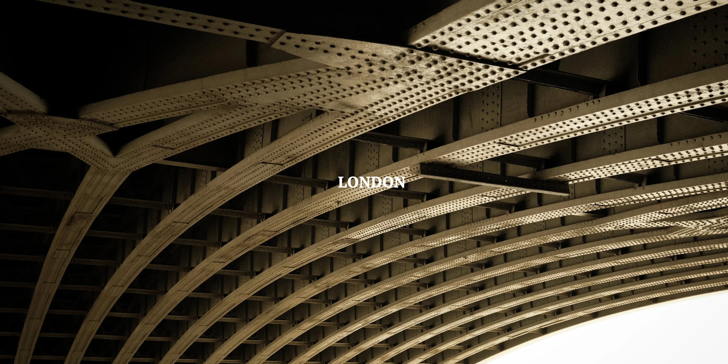 A bridge or tunnel structure with metal beams and a dark interior, labeled "LONDON" at the center.