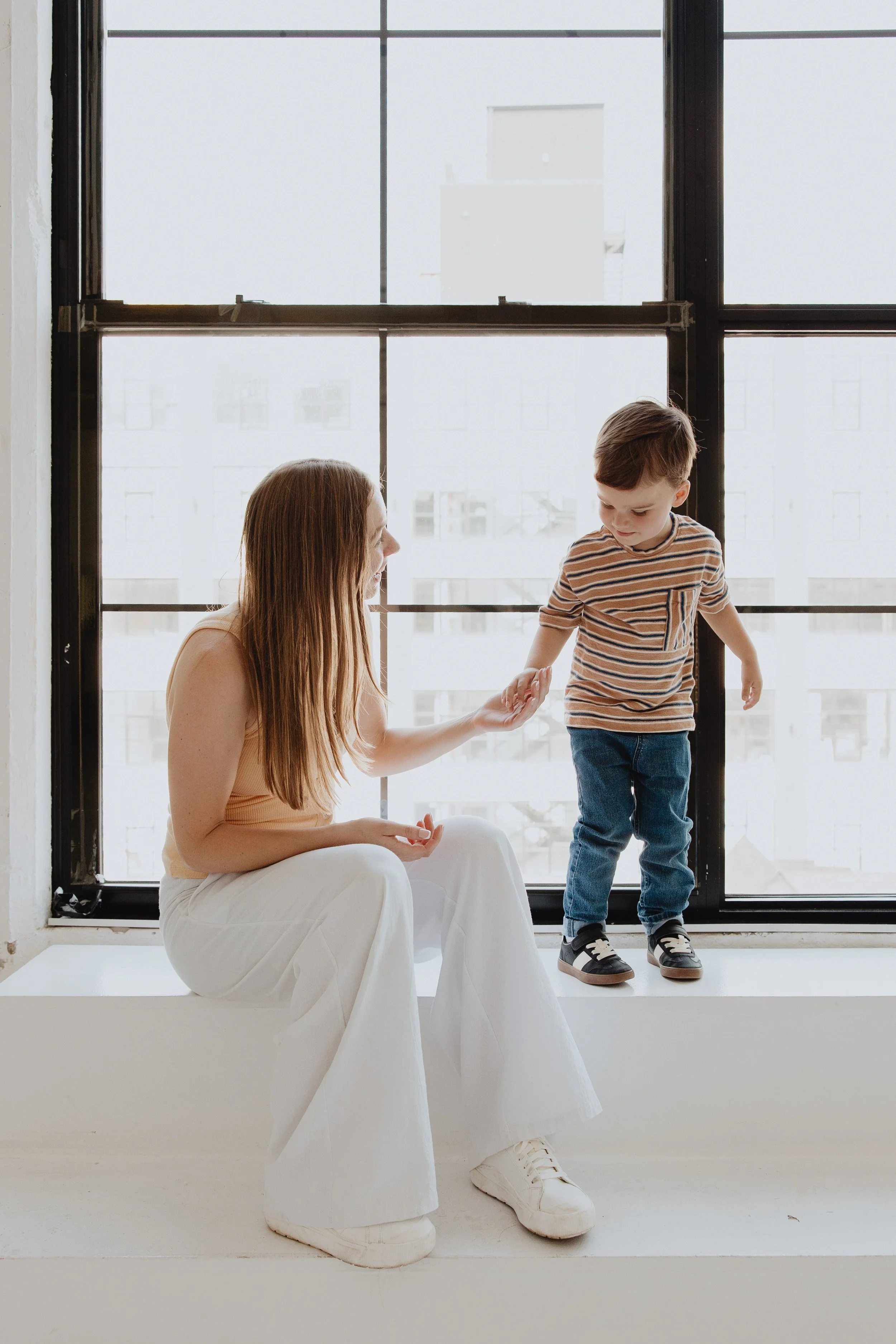 Toddler and adult holding hands