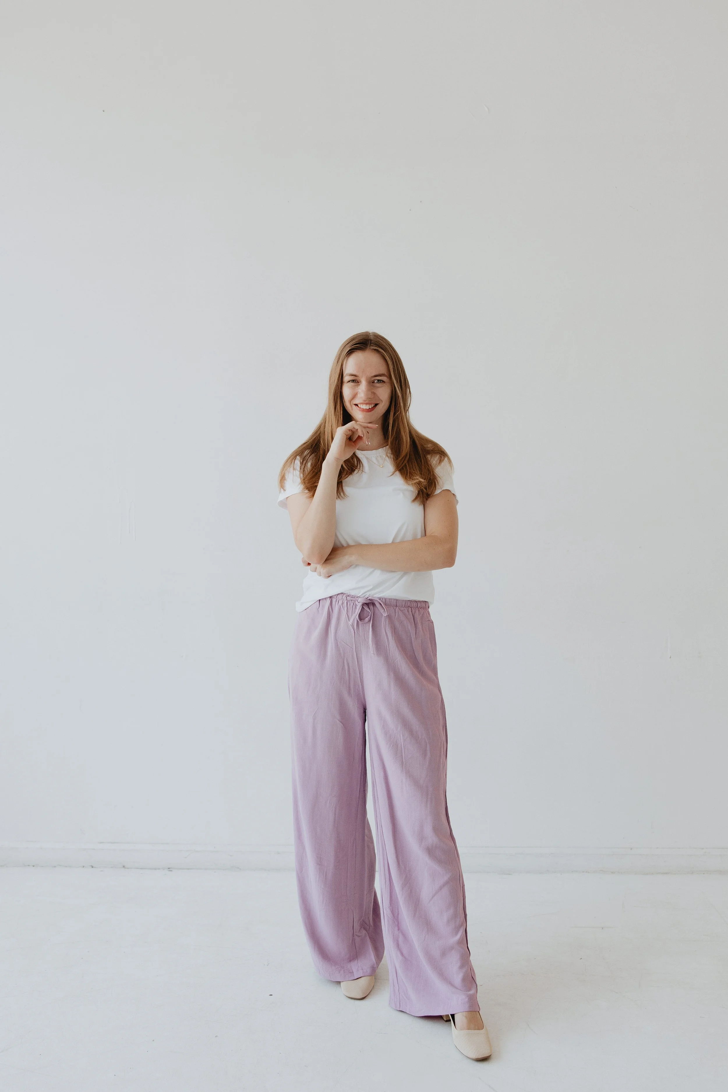 Parent Coach posing for picture, standing, with hand under chind