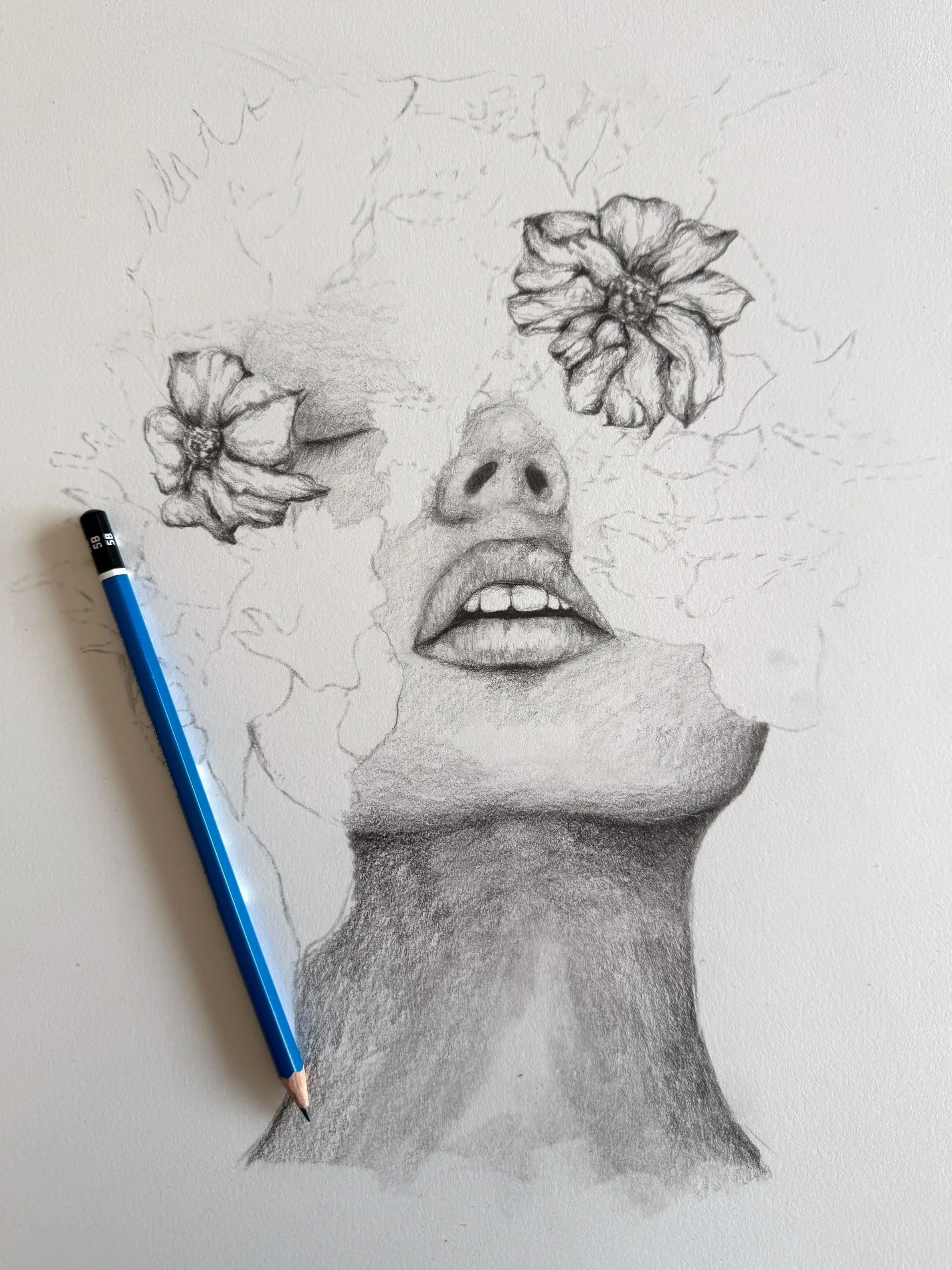 A black and white pencil drawing of a human face with flowers covering the eyes and forehead, with lips slightly open. A blue pencil is placed on the left side of the drawing.
