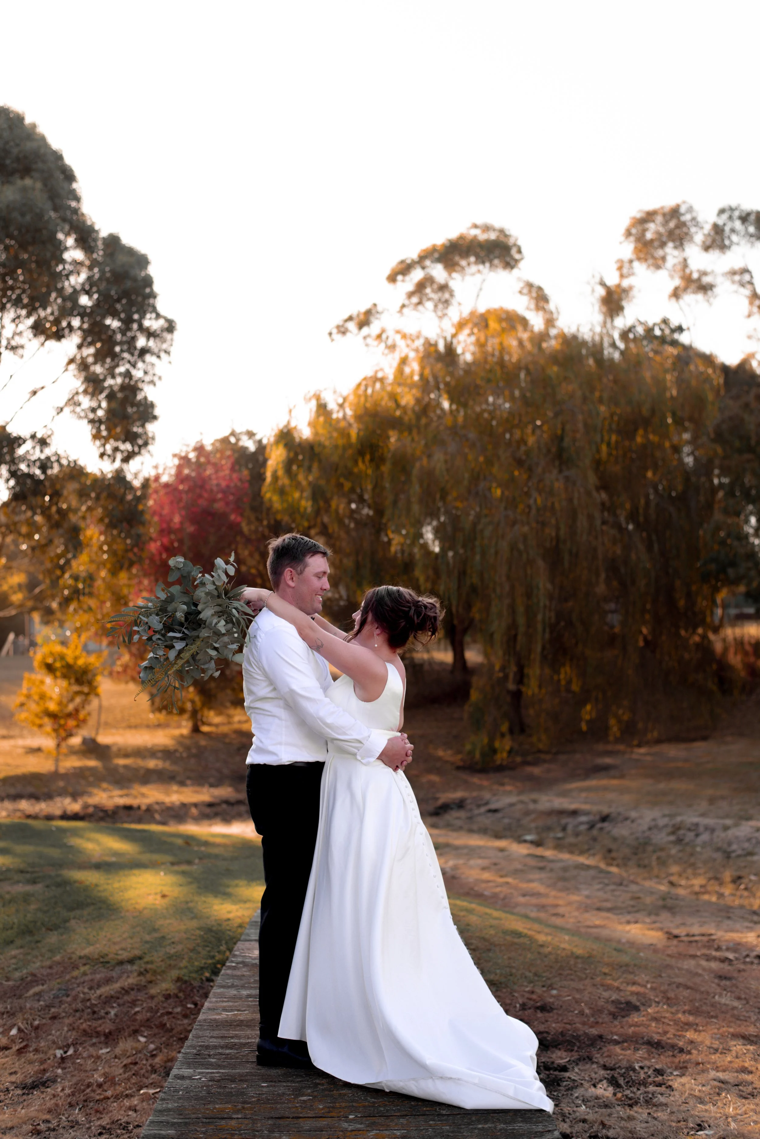 couple smiling at each other during golden hour sunset