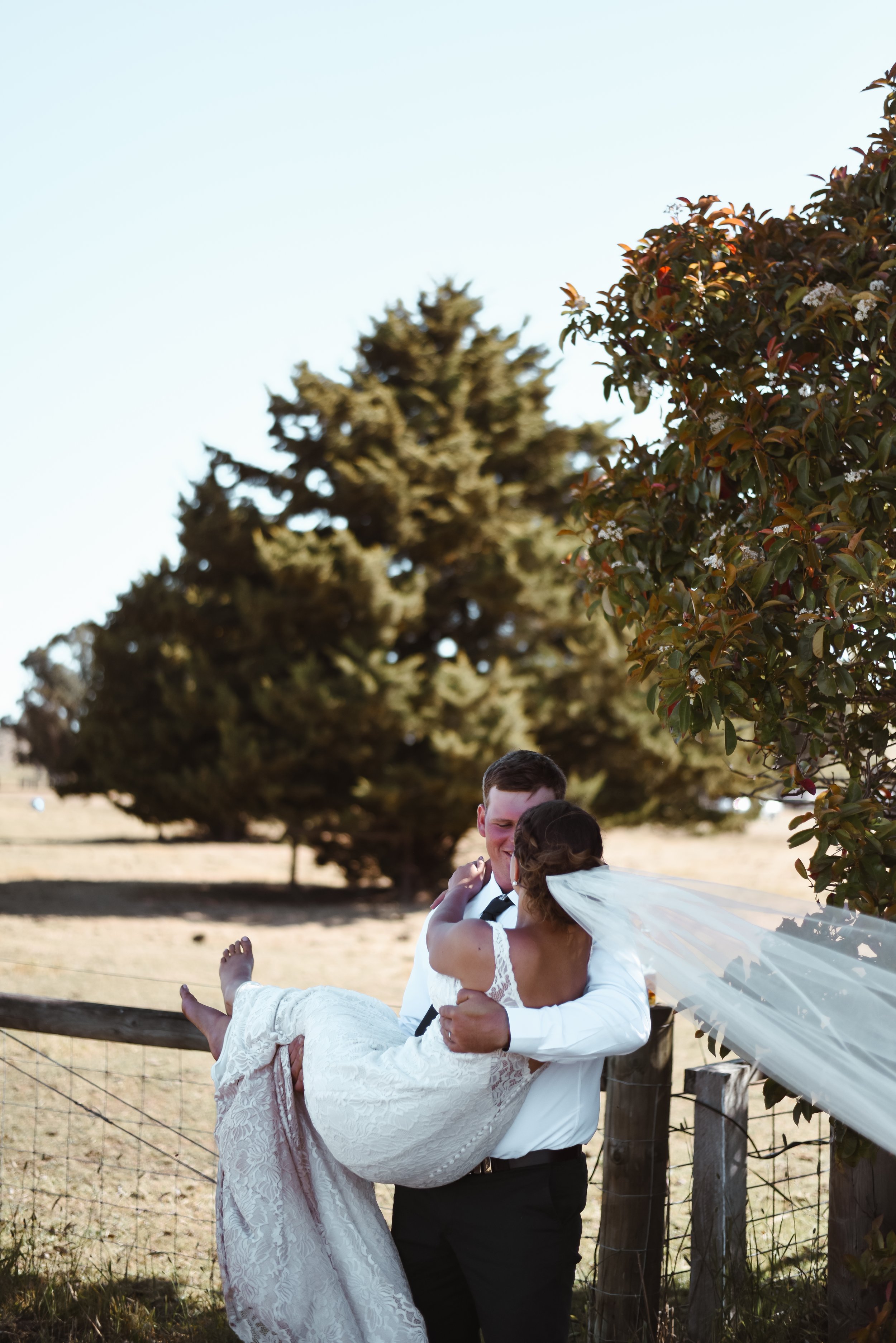 groom picking up his bride and twirling her around