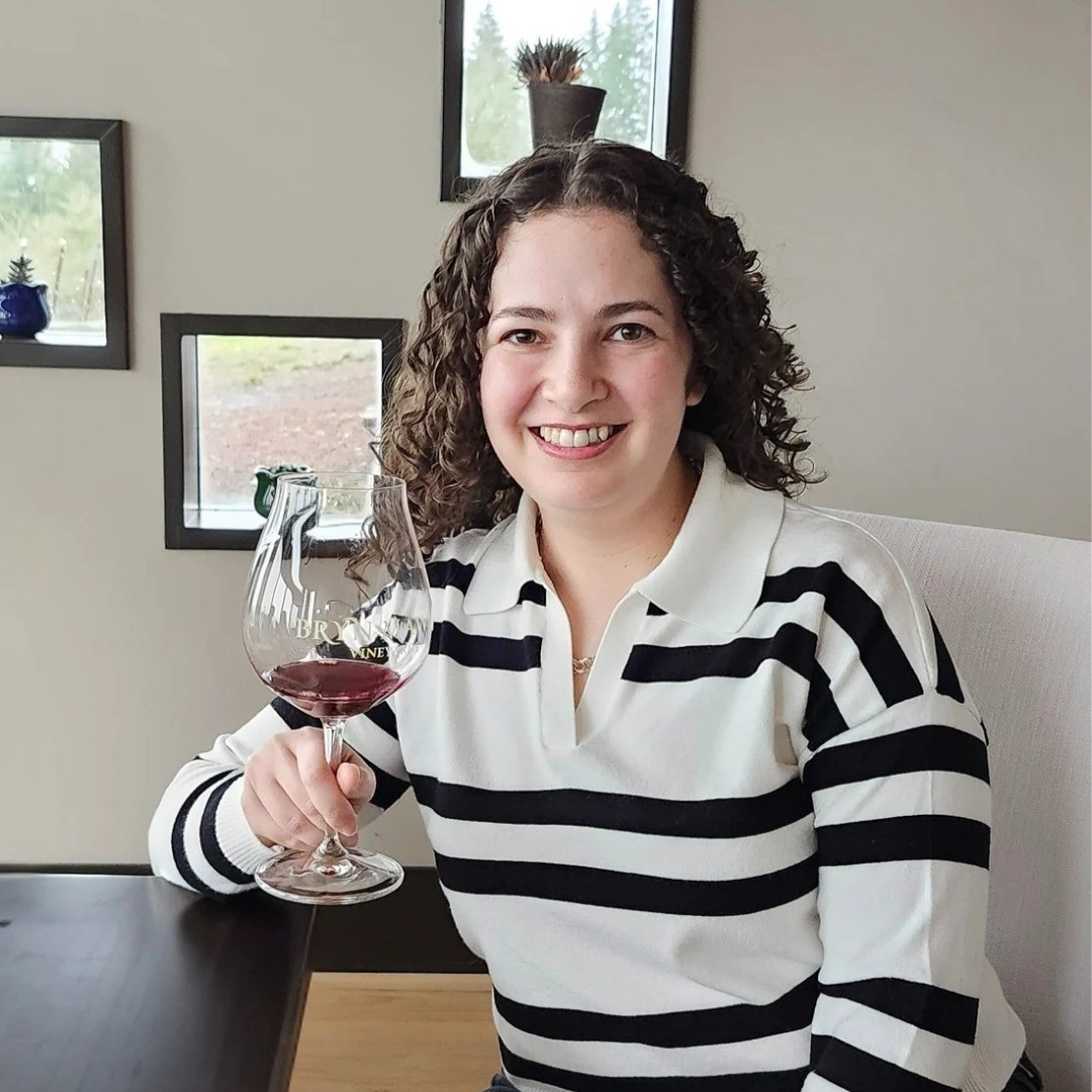 Image of our owner and founder holding a wine glass