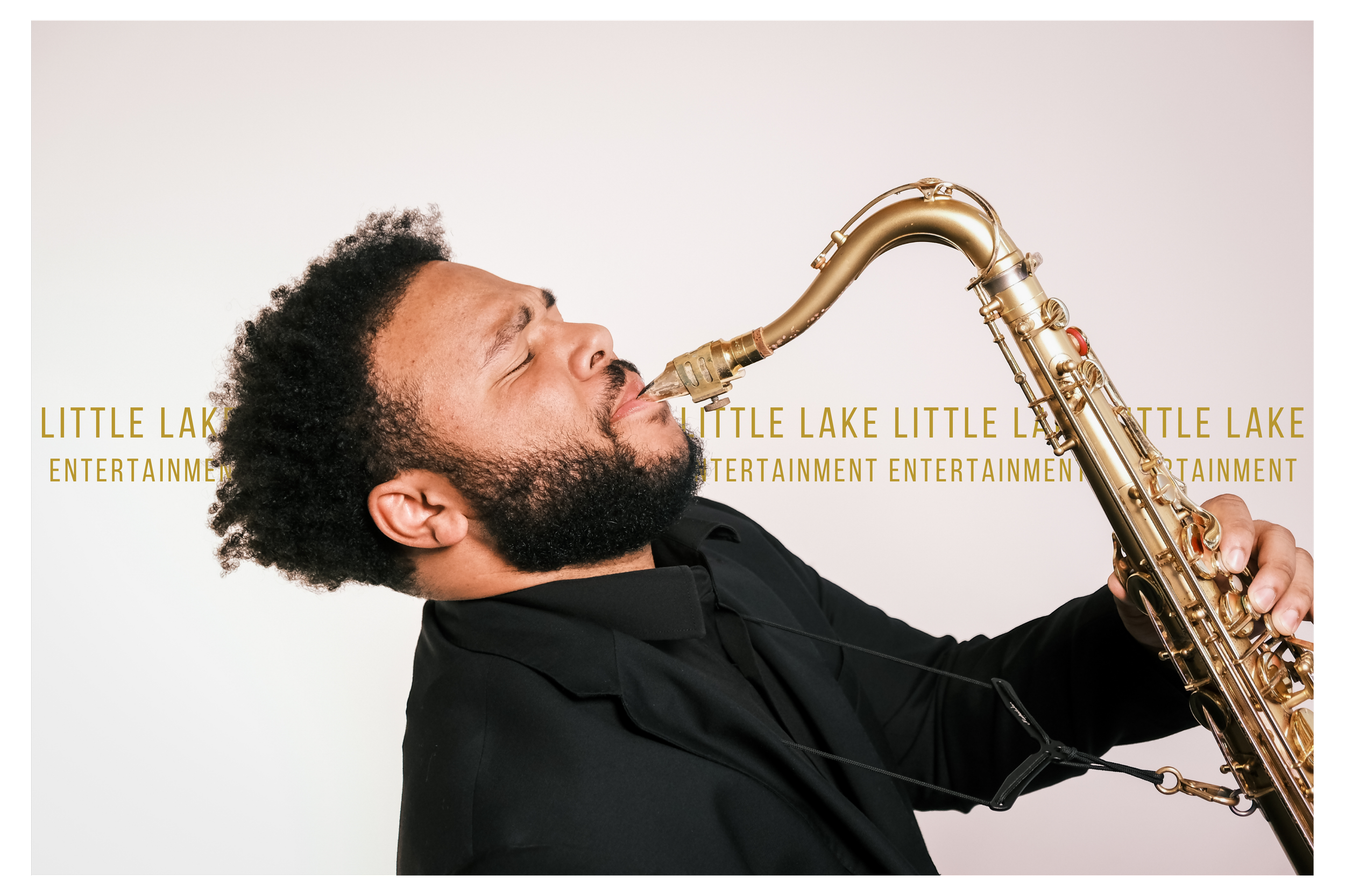 A man playing a saxophone with his eyes closed, wearing a black shirt, in front of a white background with yellow text that reads 'LITTLE LAKE ENTERTAINMENT' repeatedly.