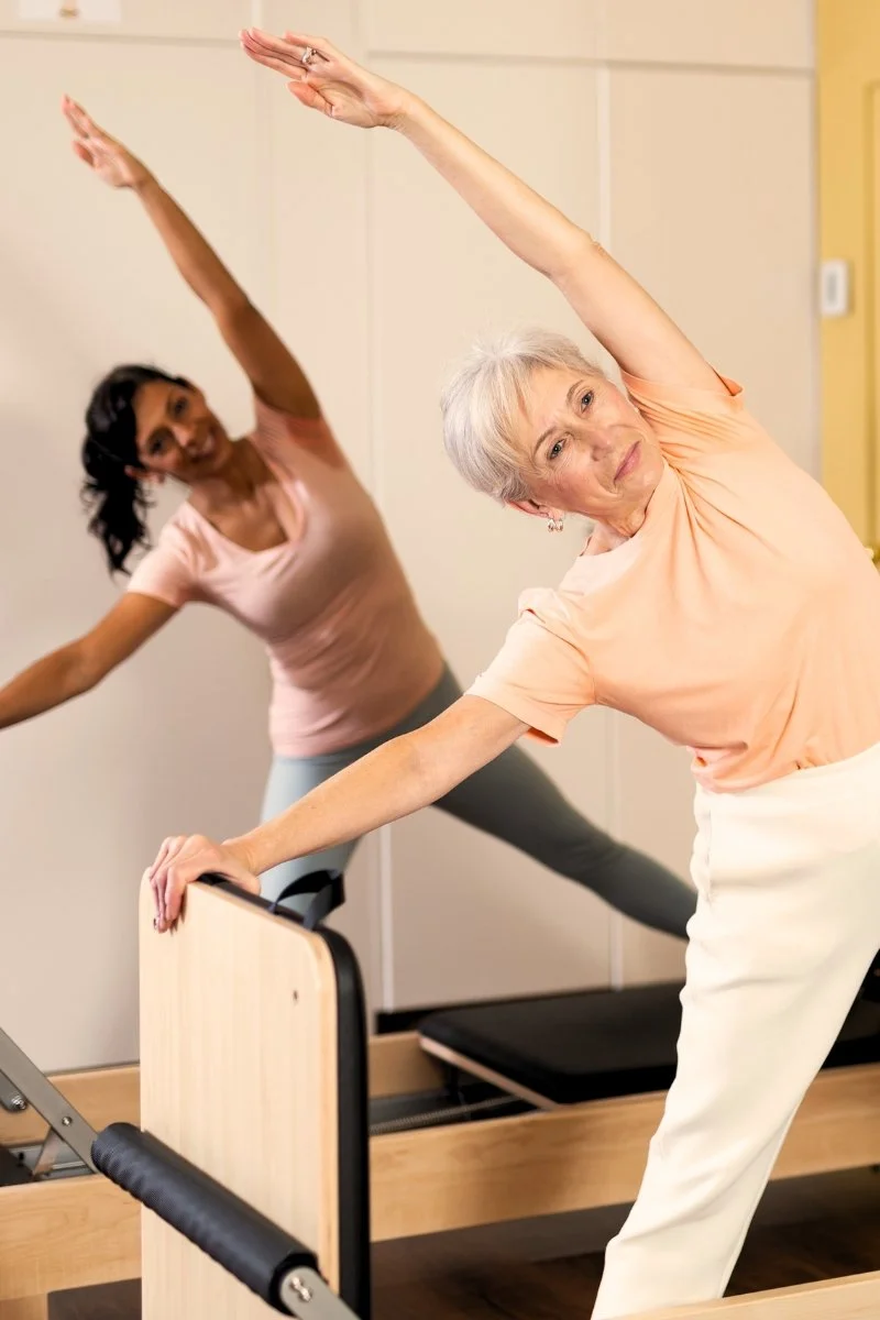 two ladies doing reformer pilates