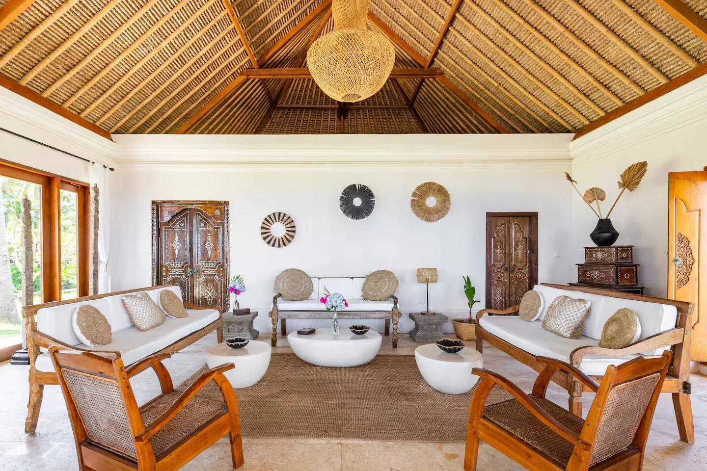 Private seafront villa in Bali with palm trees and pool, setting for a small, intentional retreat.