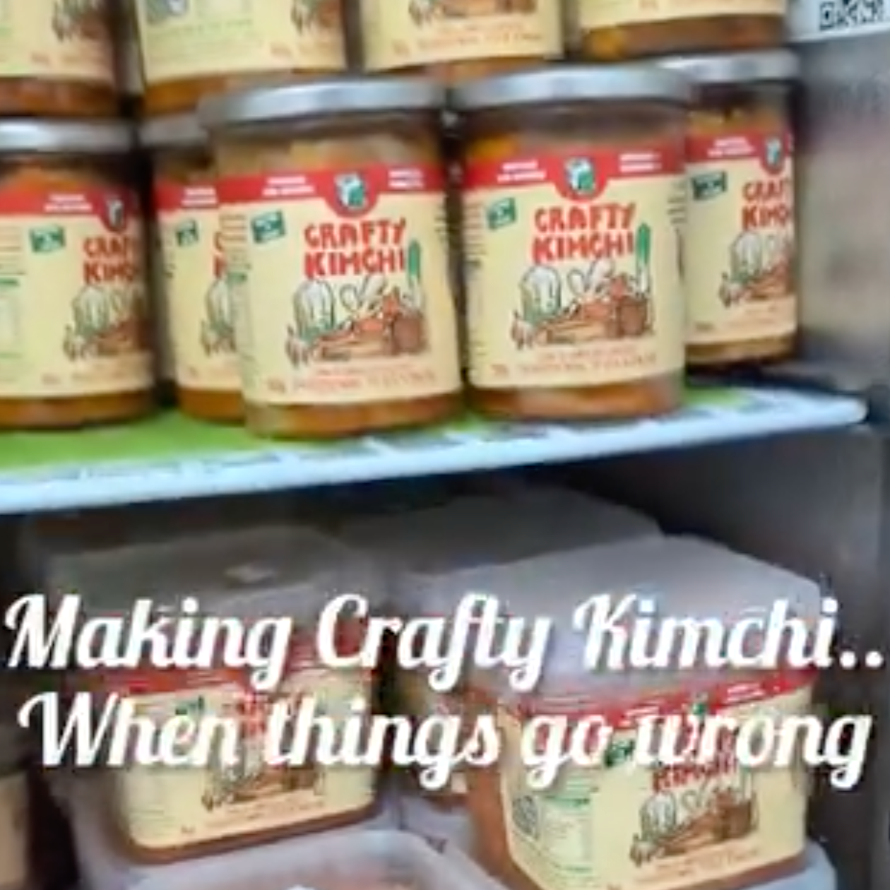 Cans of Crafty Kimchi stacked on a shelf in a store.