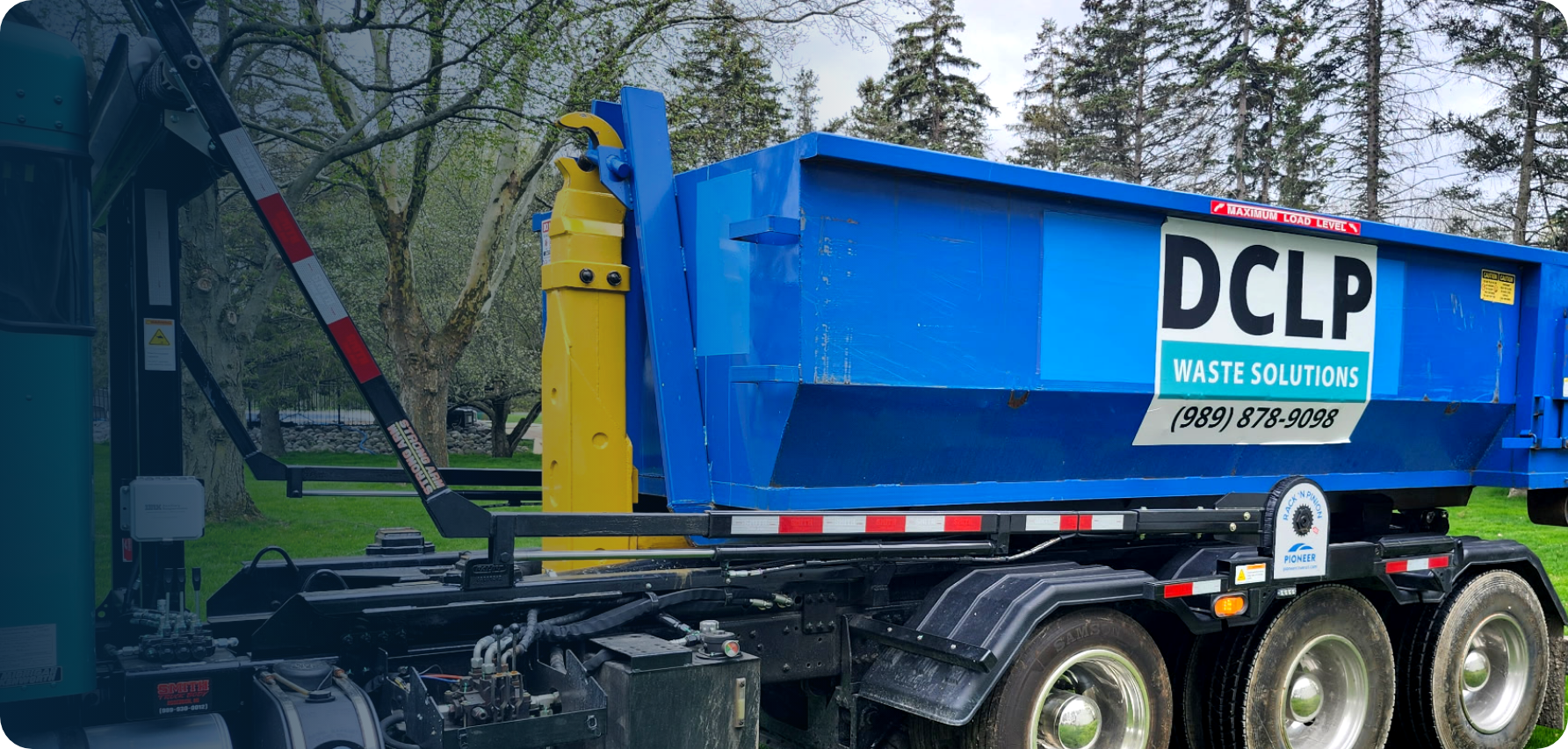 DCLP Solutions roll-off truck providing commercial and residential waste management services.