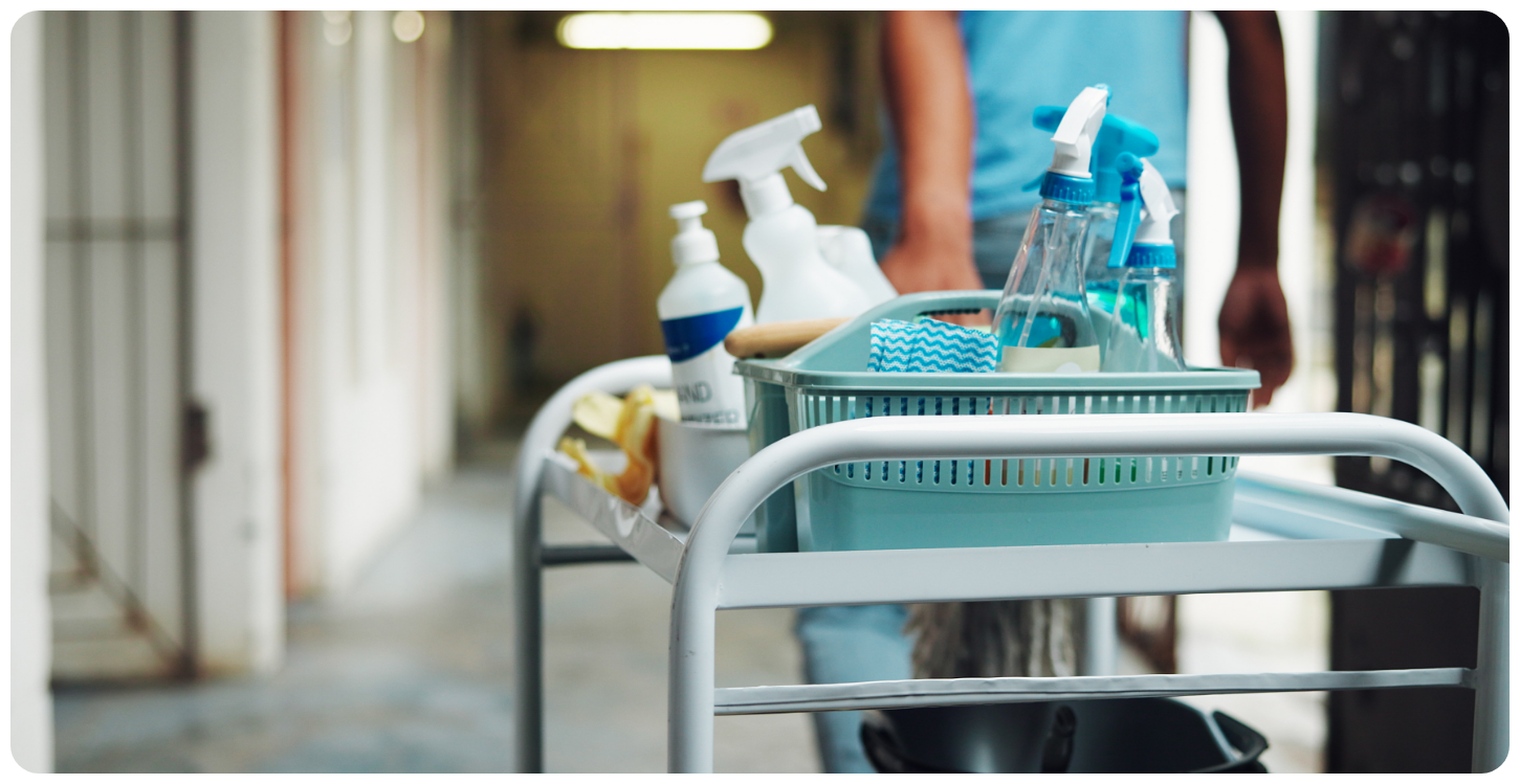 Commercial cleaning cart with janitorial supplies for facility services.